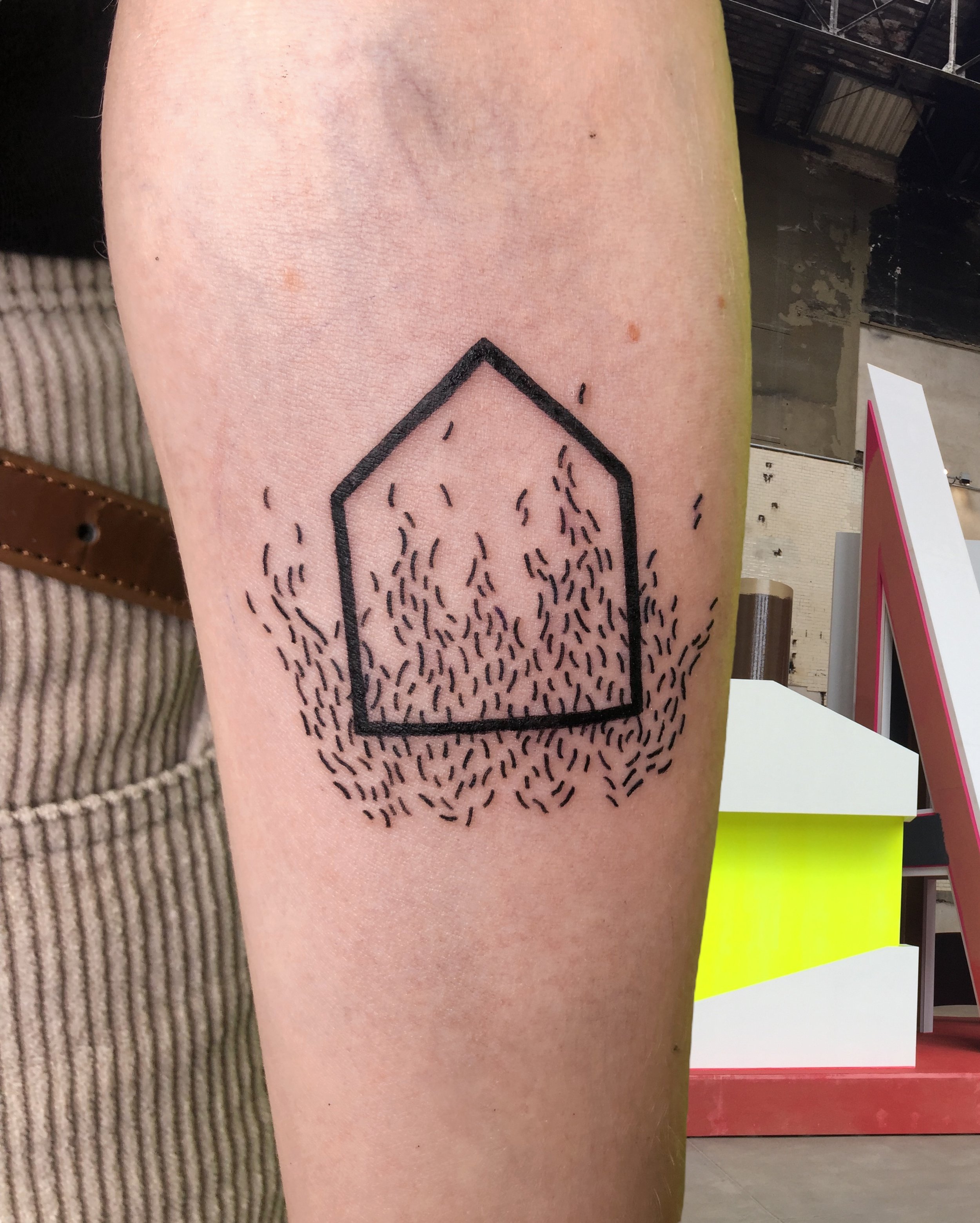 Minimal abstract tattoo of a house and flames.JPG