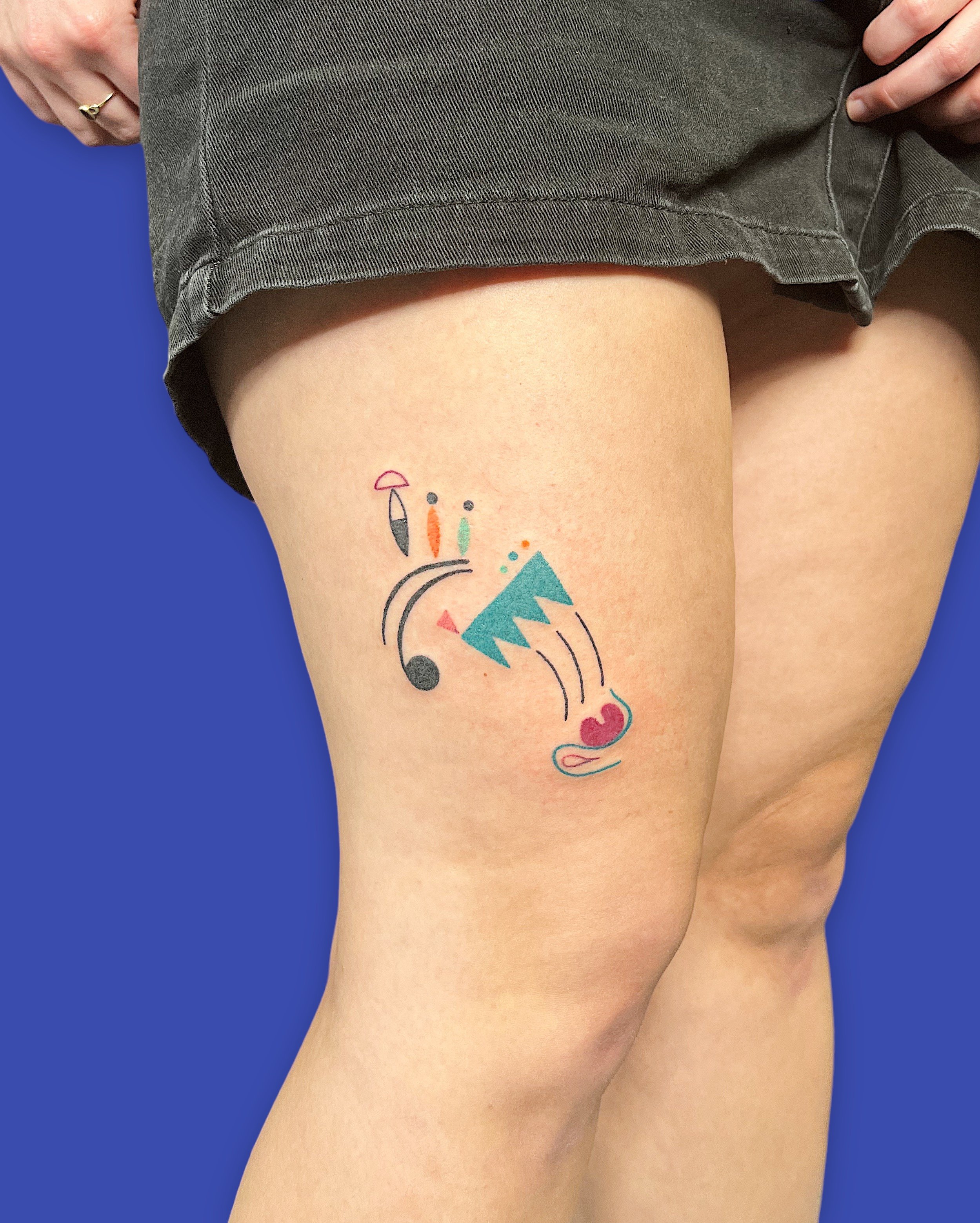 Abstract face composed by small colorful elements tattooed on upper leg by Madame Unikat.JPG