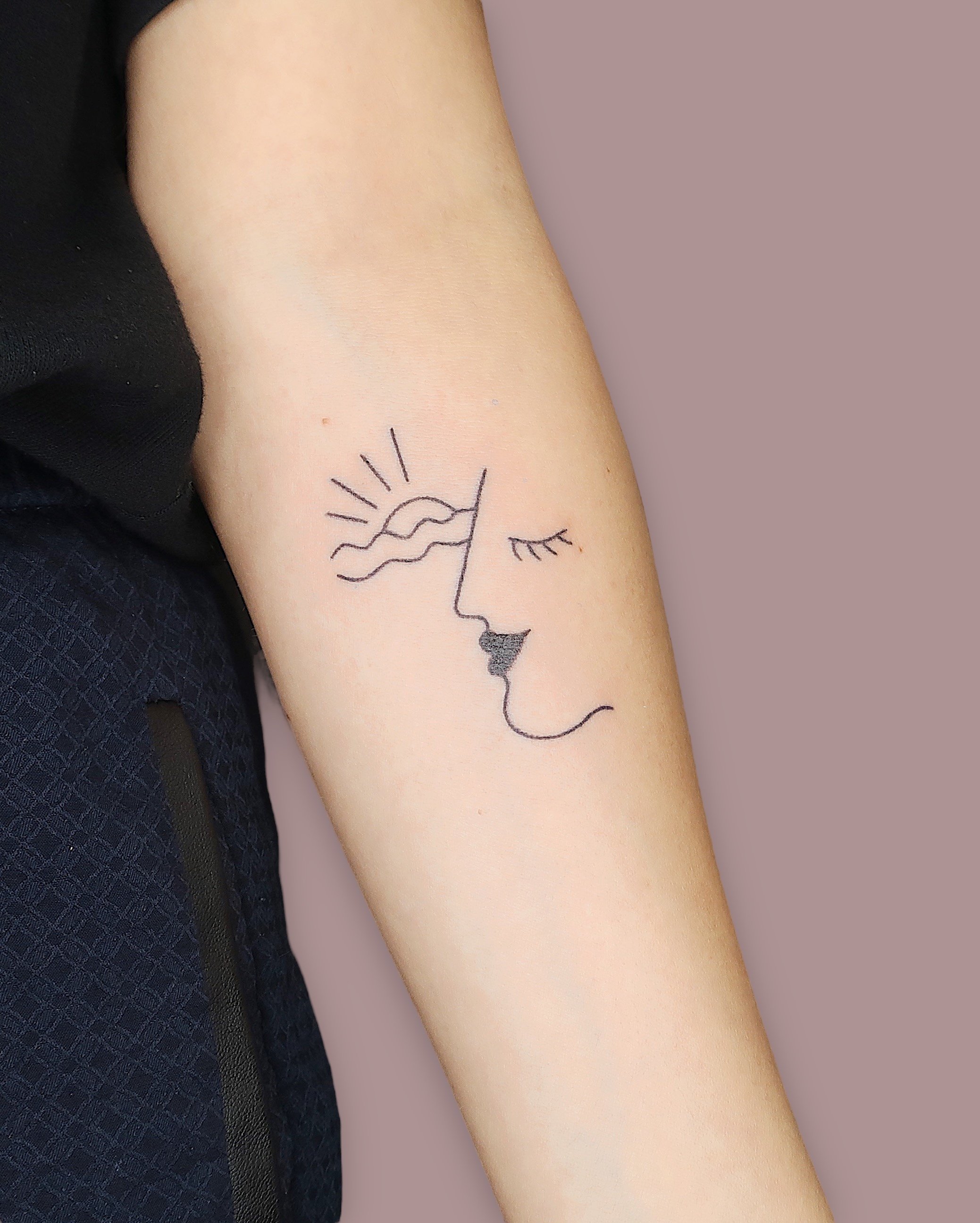 Simple minimal face with a sun and the sea tattooed by Madame Unikat.JPG