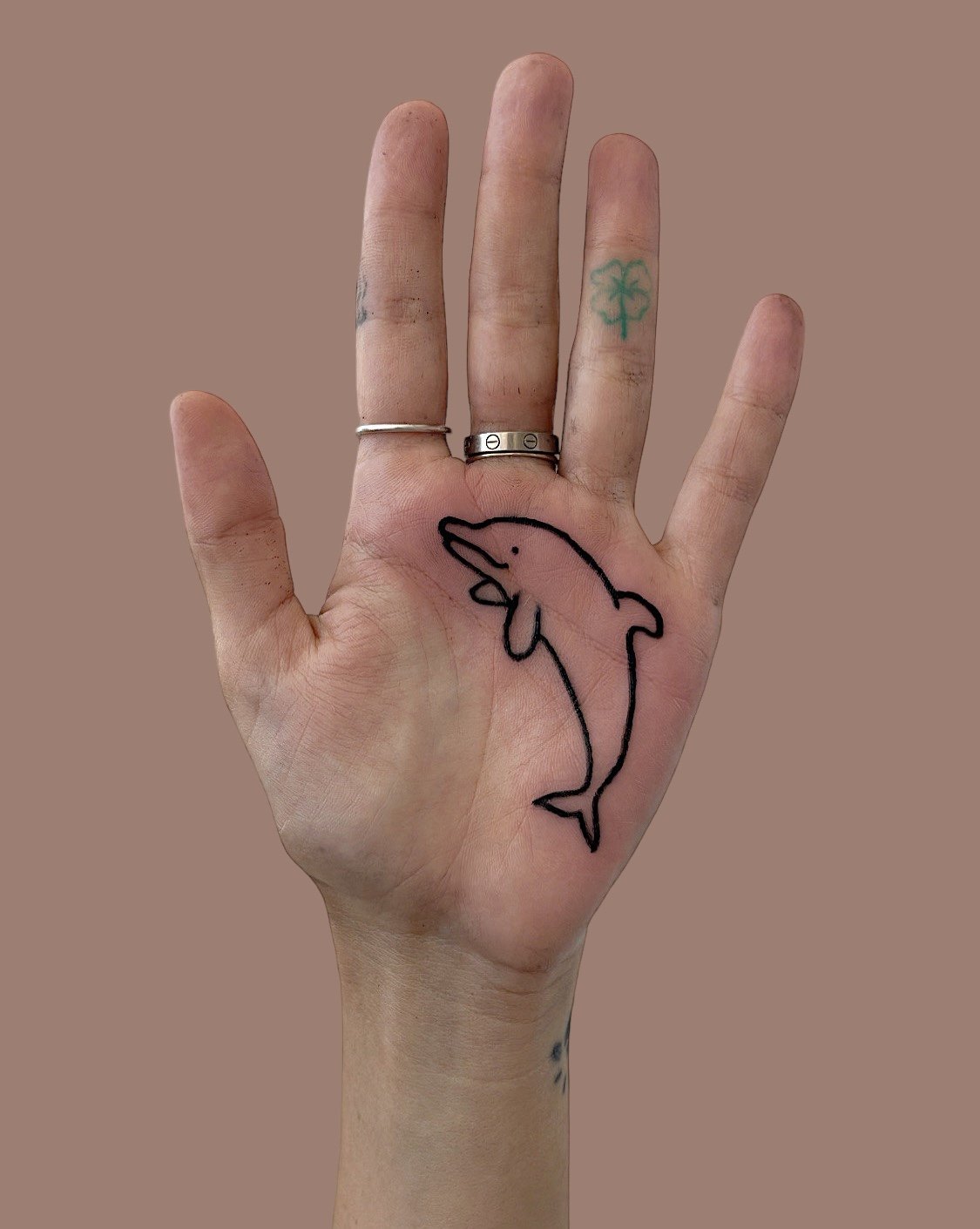 Dolphin palm tattoo by tama bar.JPG