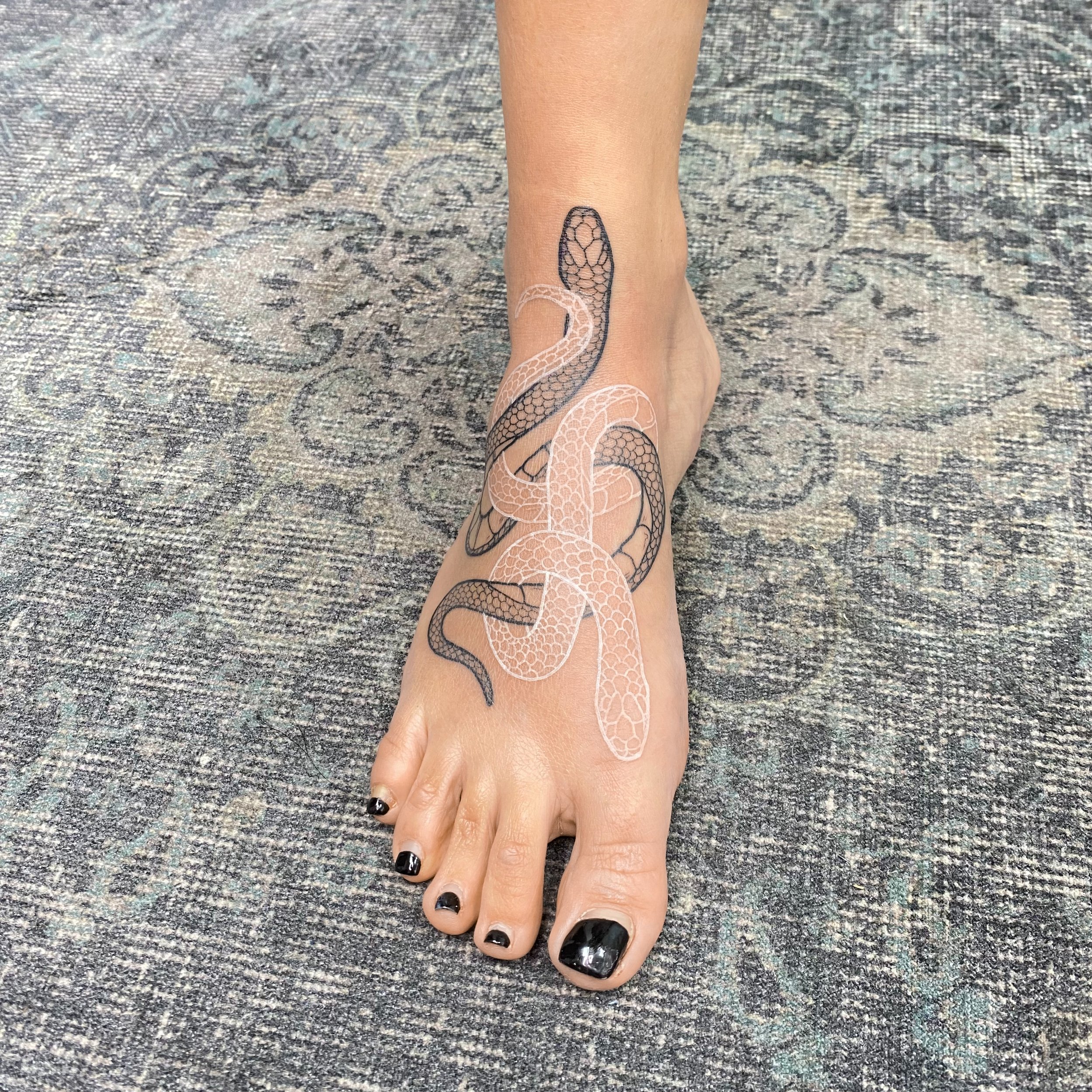 Snakes tattooed on foot by boy.brush.ttt.JPG