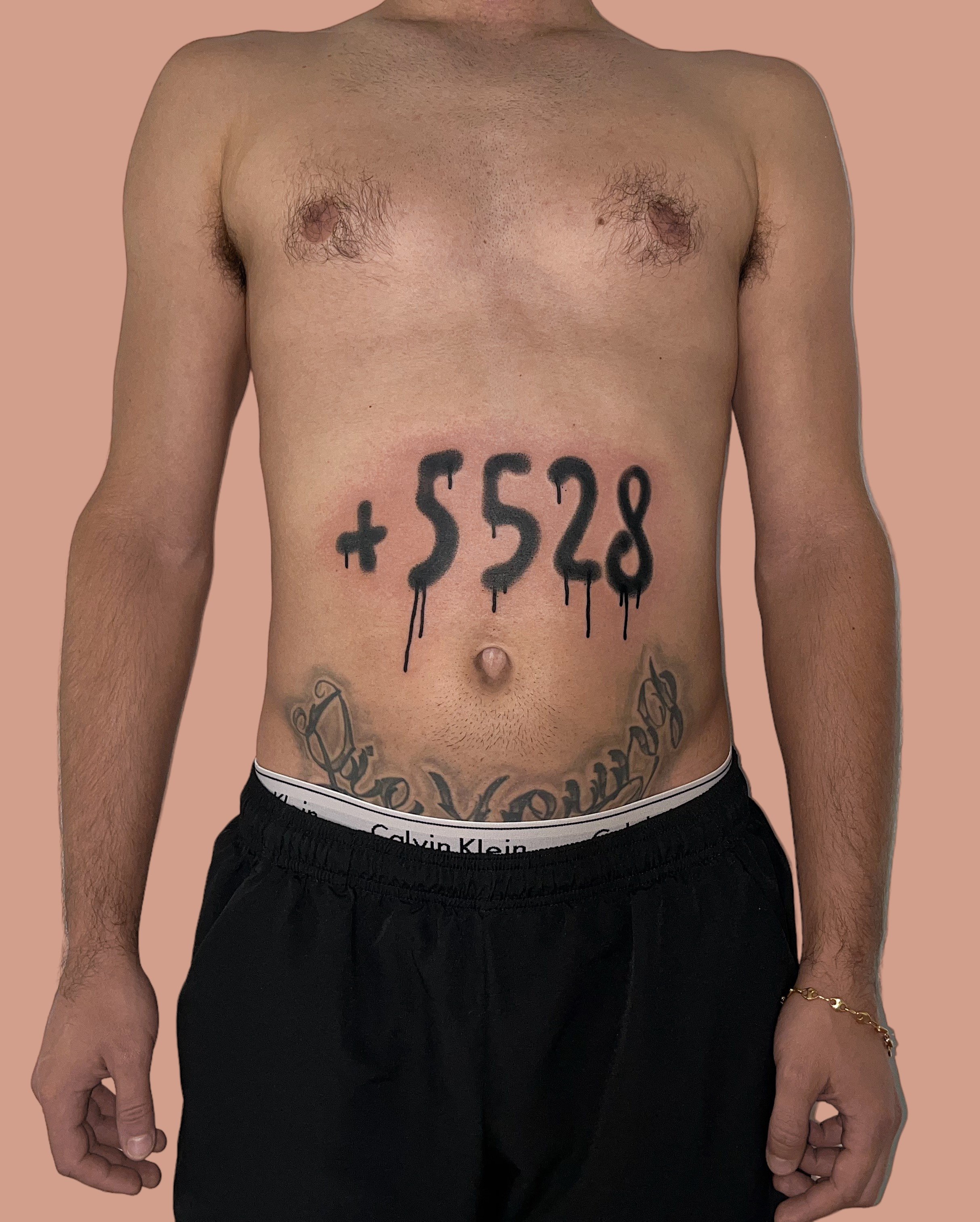 Graphiti like number tattooed on belly by Vitya lyuty.JPG