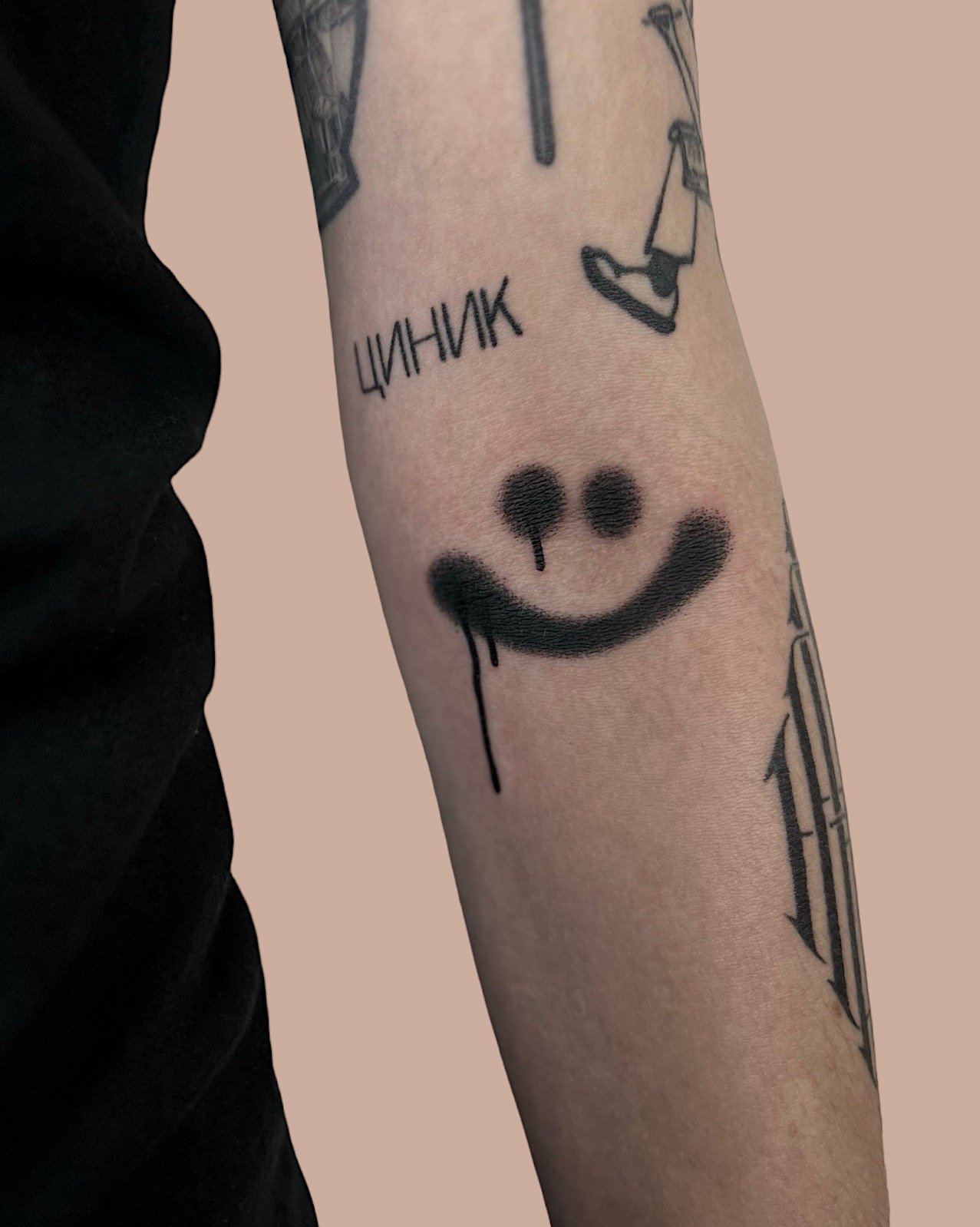 Graphiti like smiley tattooed inside the elbow by Vitya lyuty.JPG