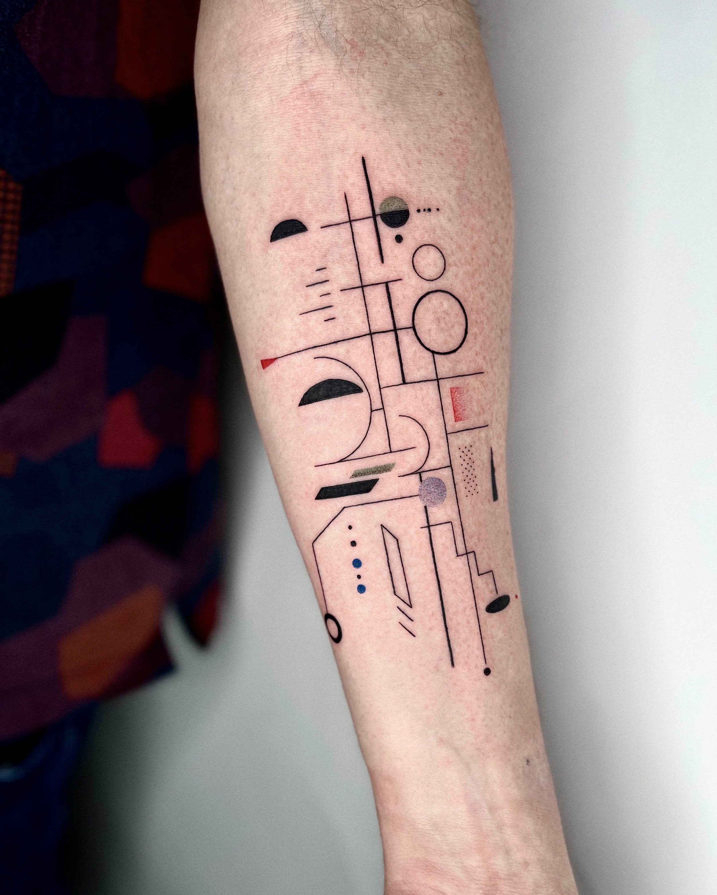 Abstract composition on inner arm tattooed by kirii lines.JPG