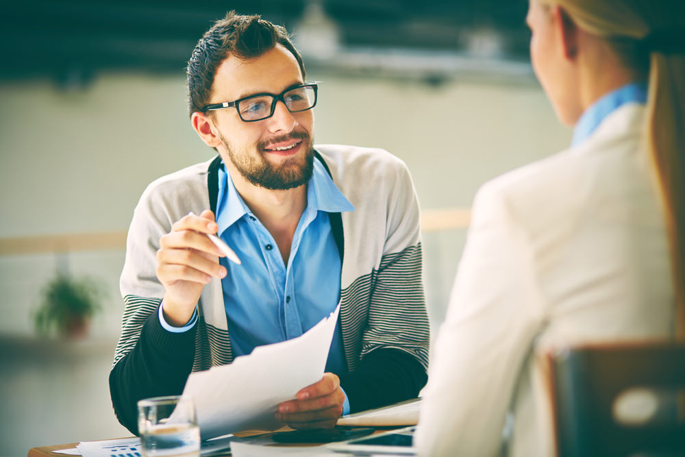 worker in professional services firm discussing with colleague.jpeg