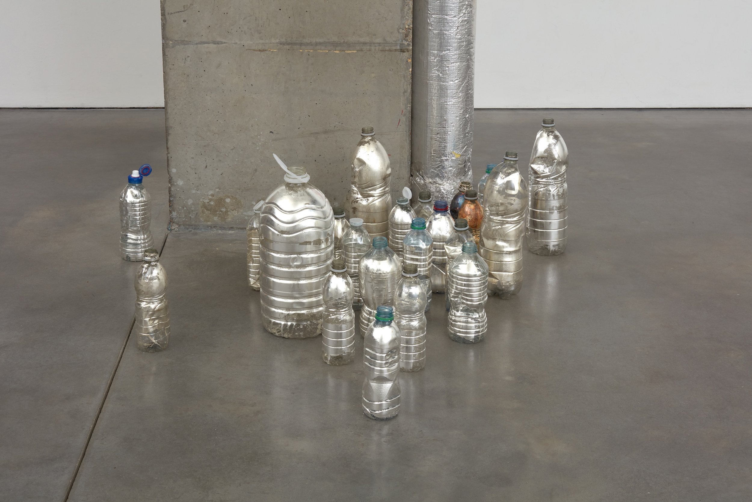  Print, 2023  Various plastic bottles, unsealed silver leaf  Dimensions variable 