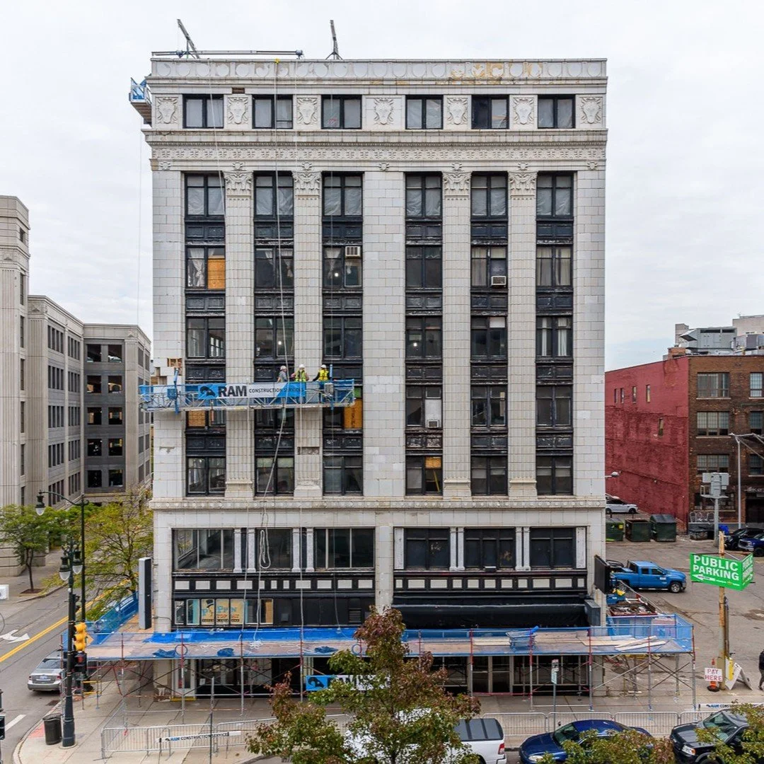 The Merchants Building, constructed in the 1920&rsquo;s, is underdoing fa&ccedil;ade restorations. Pictured here are team members from Kraemer Design, RAM Construction and Resurget Engineering on a swing stage at Broadway Street to assess fa&ccedil;a