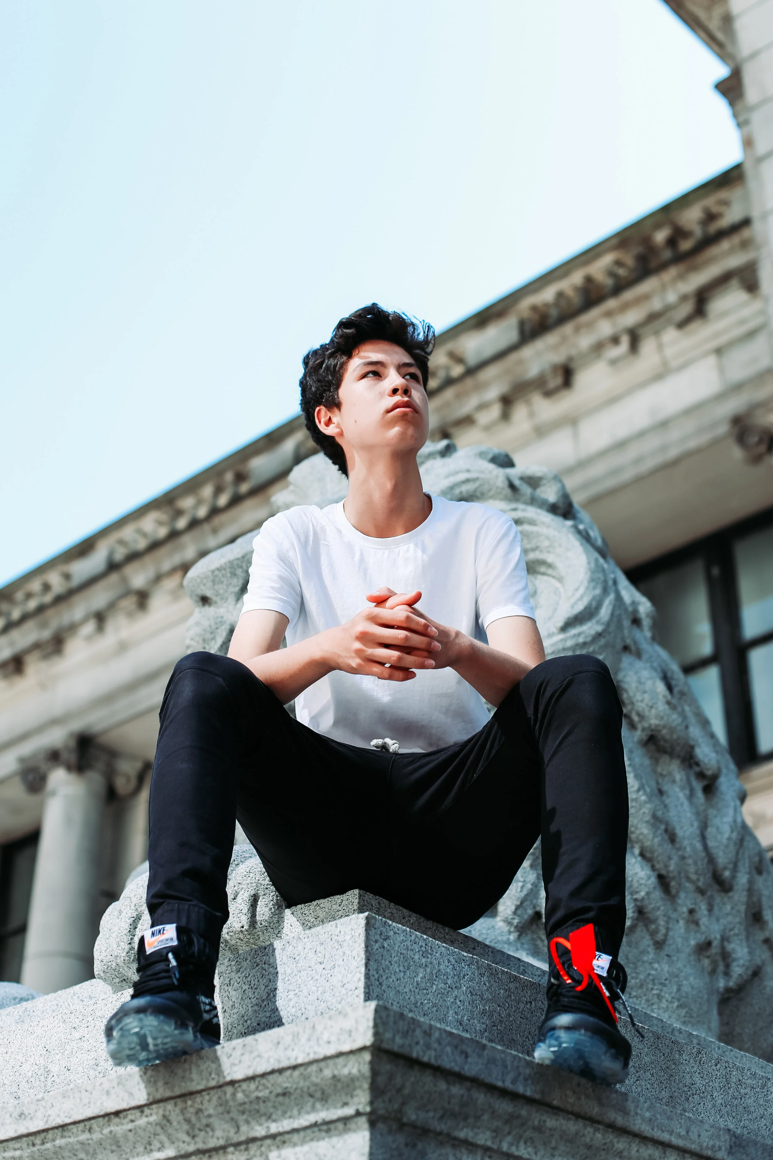 Boy Sitting On Statue.jpg