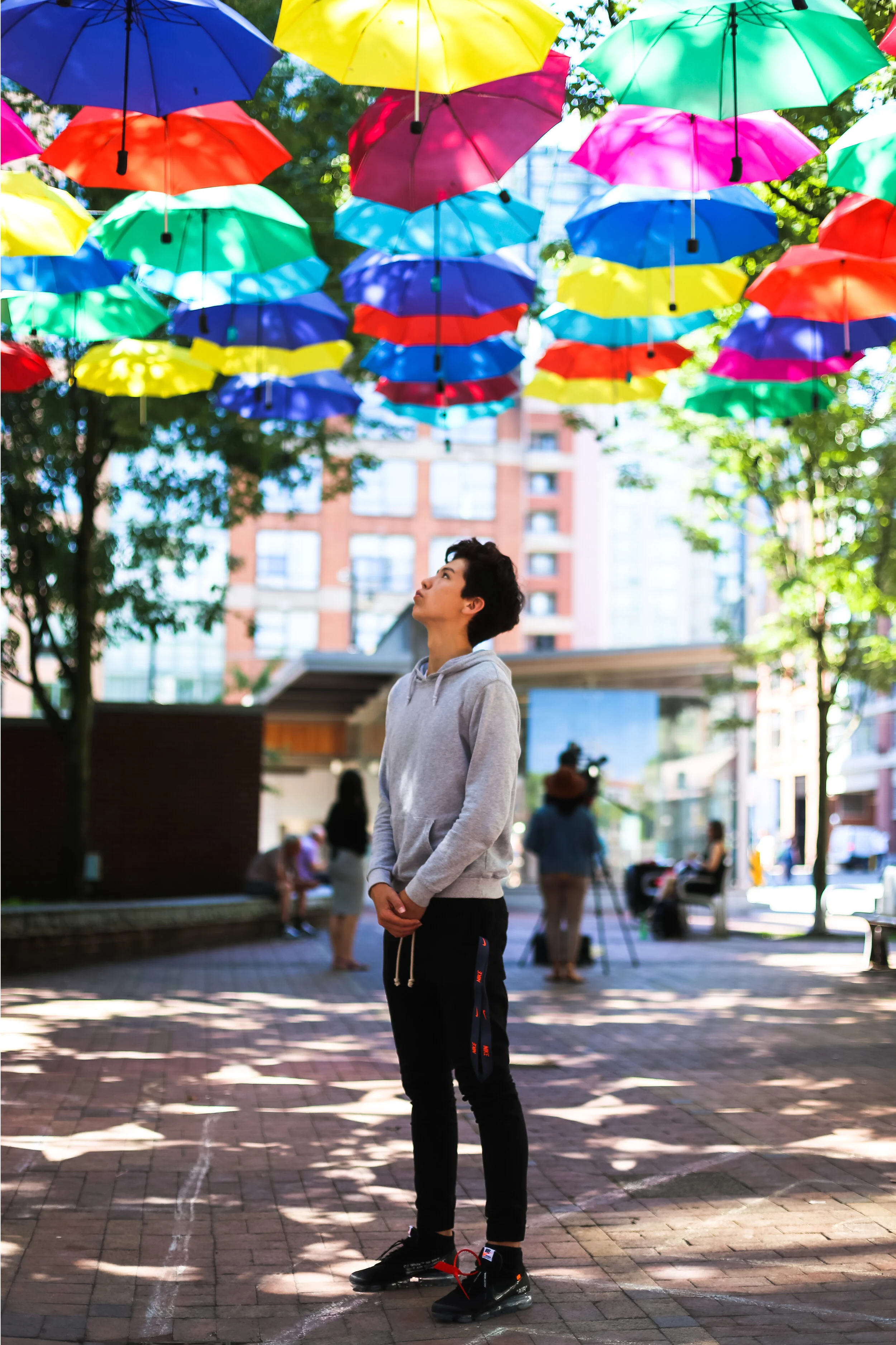 Boy Under Umbrellas.jpg