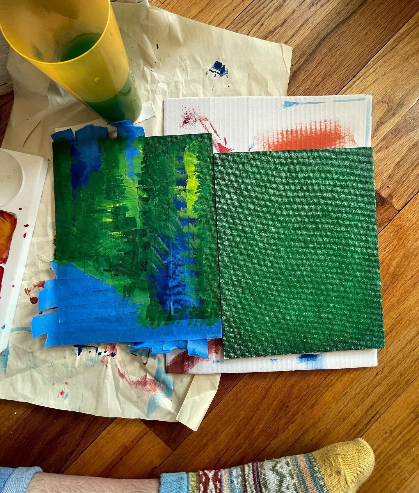 painting a layer of feelings a day, and covering some of the board w blue tape. two days ago it was reddish orange, yesterdays was blue (it&rsquo;s the second picture, I forgot to take one before I started adding the green), and now we&rsquo;re in my