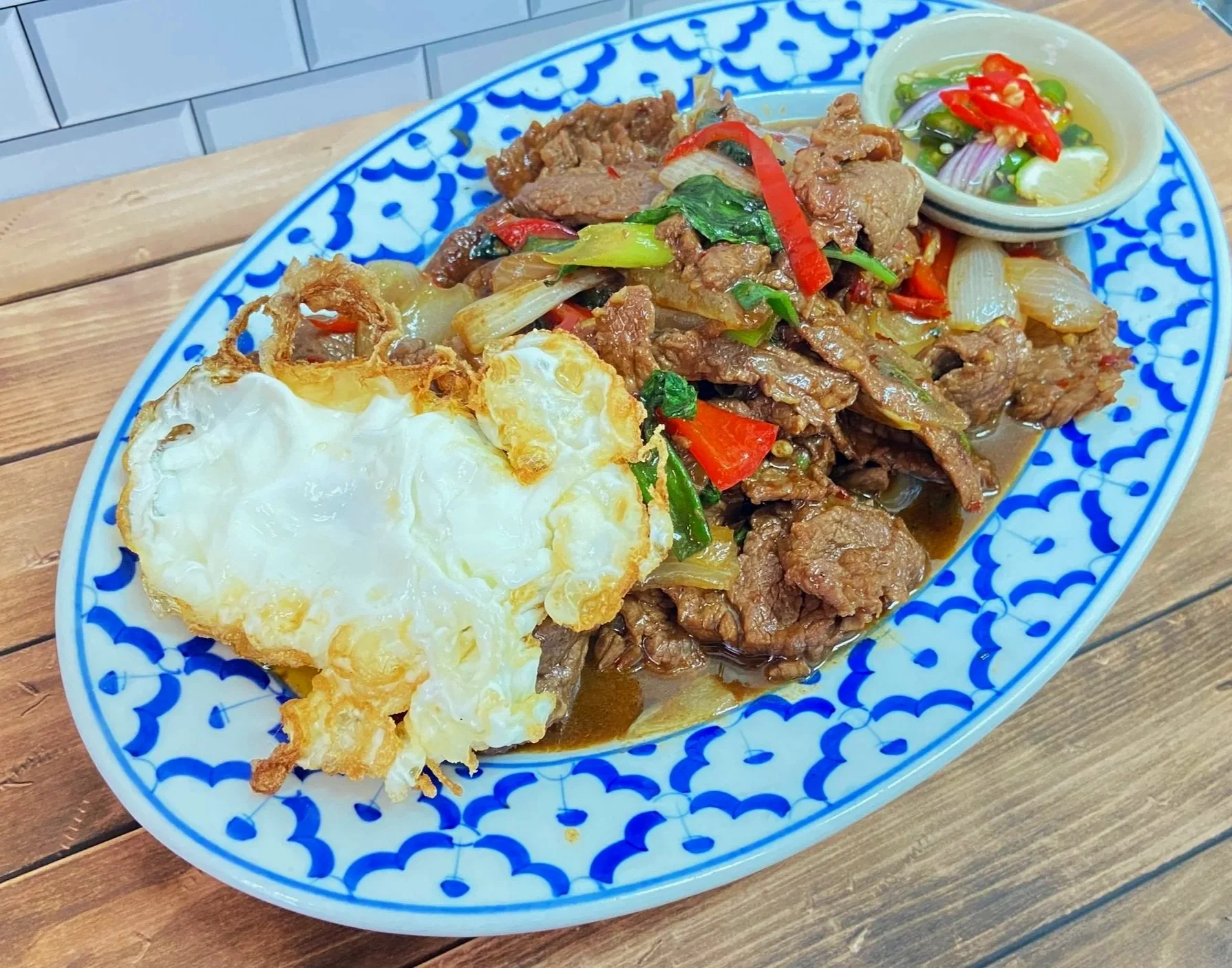 Spicy Beef Basil $25 Add Fried Egg on Top $3 , Side of Chili Fish Sauce $1