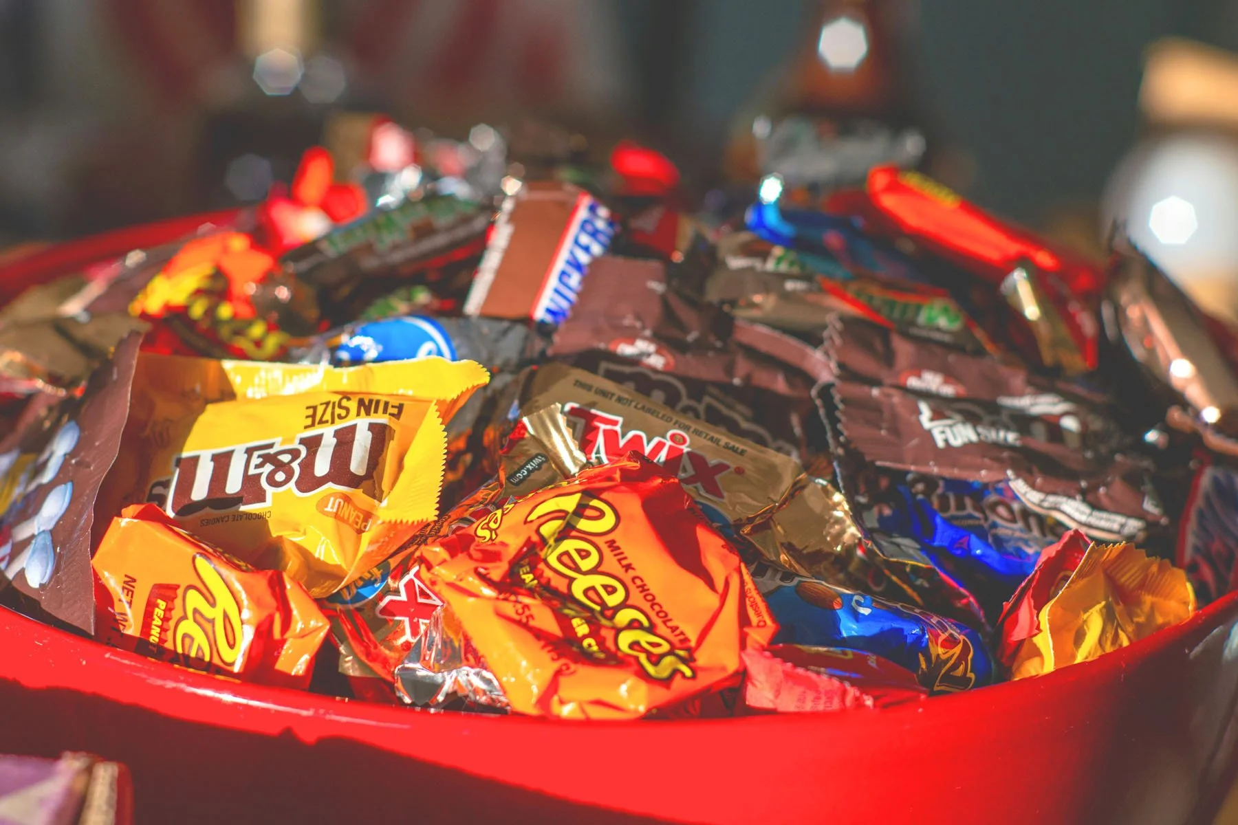 A bowl of Halloween candy can set off a binge episode and  guilt spiral because of diet culture restriction and conditioning. Photo by Douglas Clark on Unsplash.