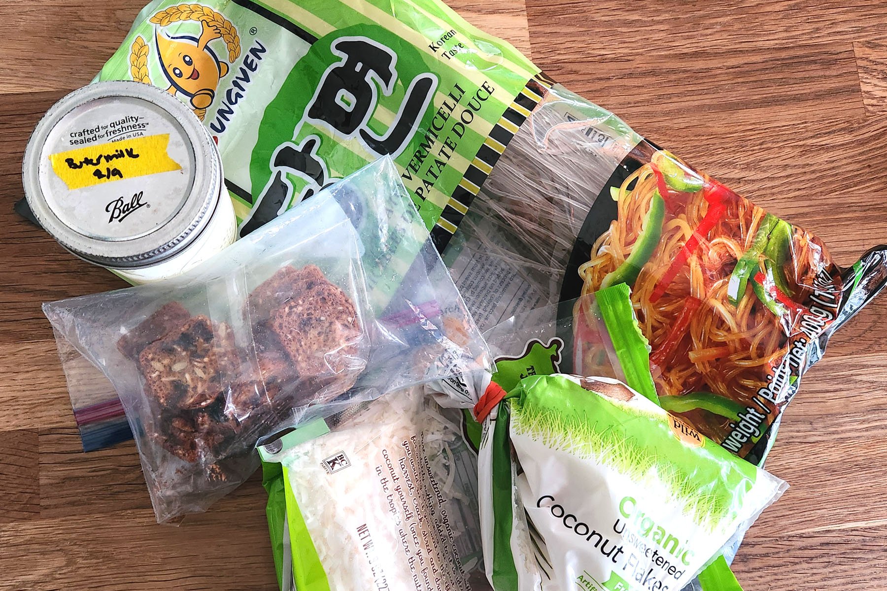 Real life pantry audit including sweet potato noodles, shredded coconut, rainforest crackers, and buttermilk.