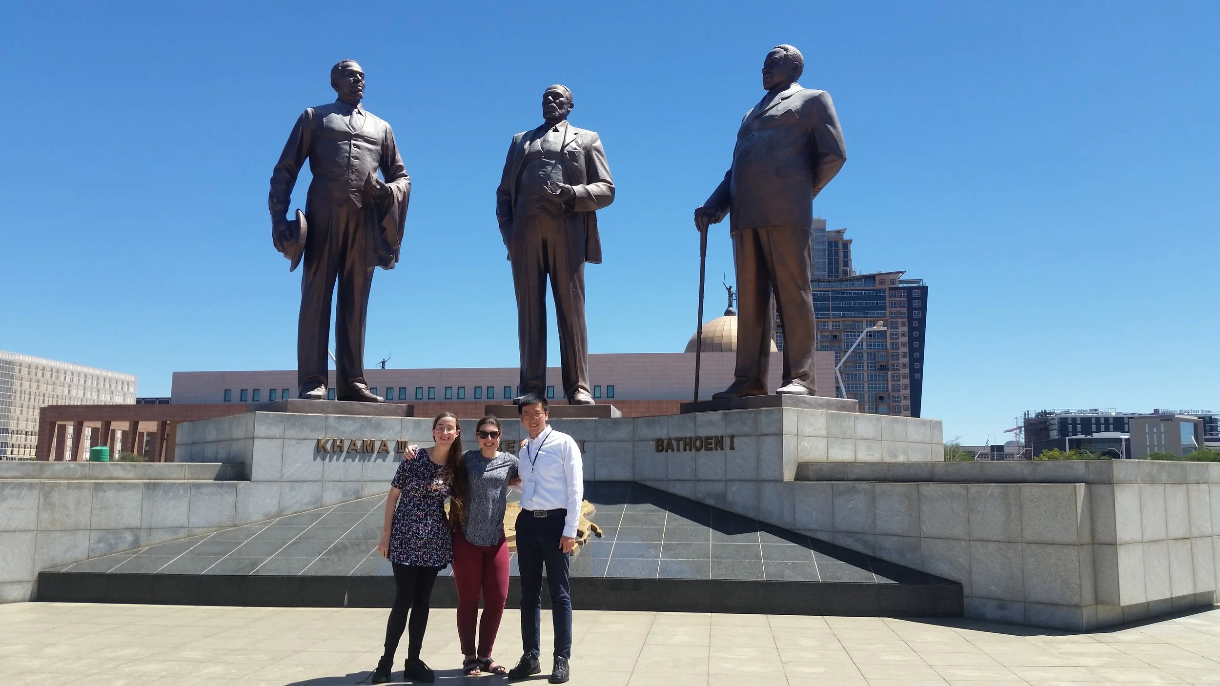 From left: Alexandria Cruz, Alex Hsain, and John Wang. Posing in front of the three chiefs statue in downtown Gaborone, Botswana.