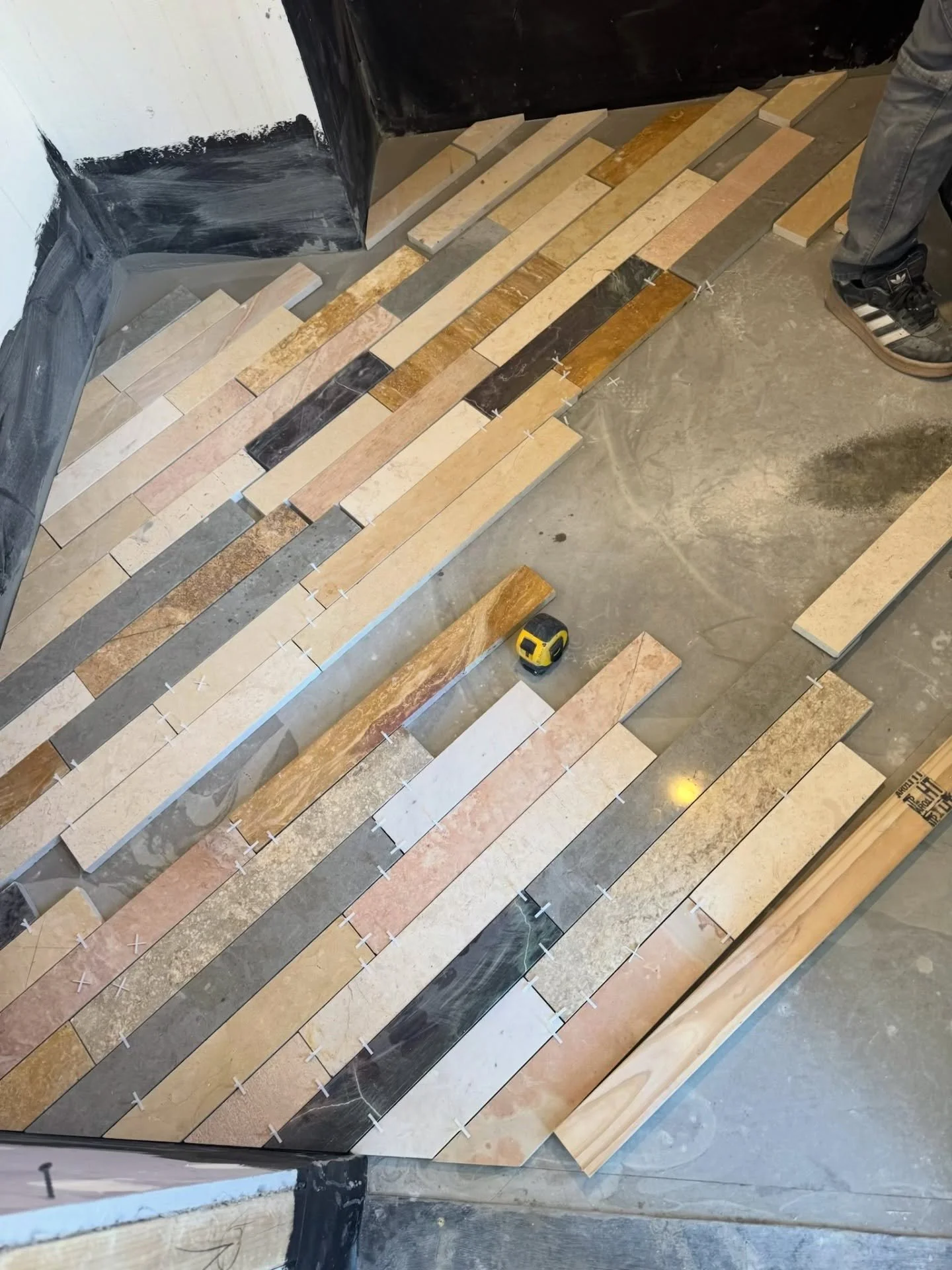 Guest bath #floortile installation in progress. The stone is a very #huntleycodesign palette that we will be complementing with grey-green painted cabinetry. Yum.
