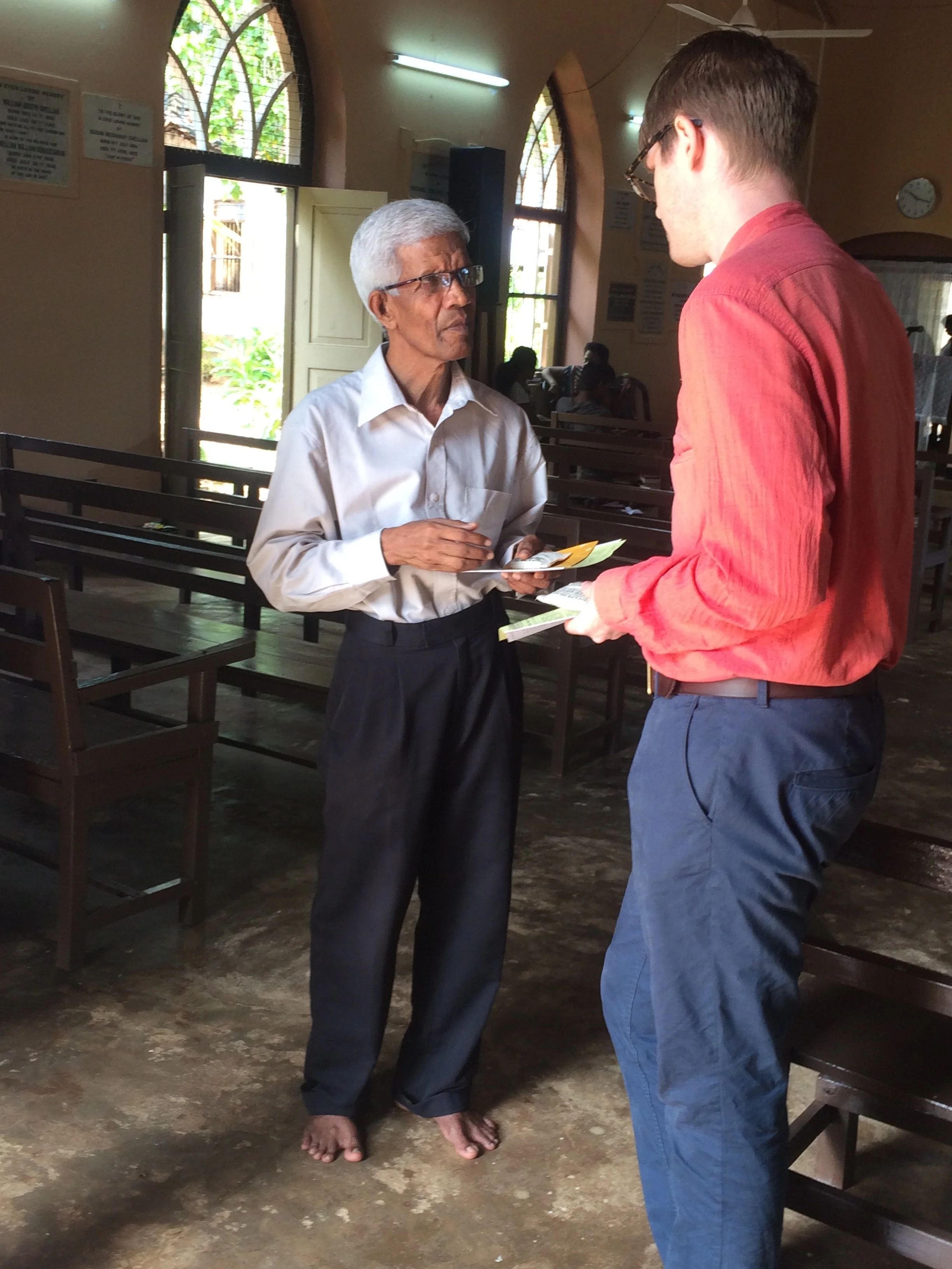 Distributing project information at Tellippalai church. Photo Credit: Henria Aton