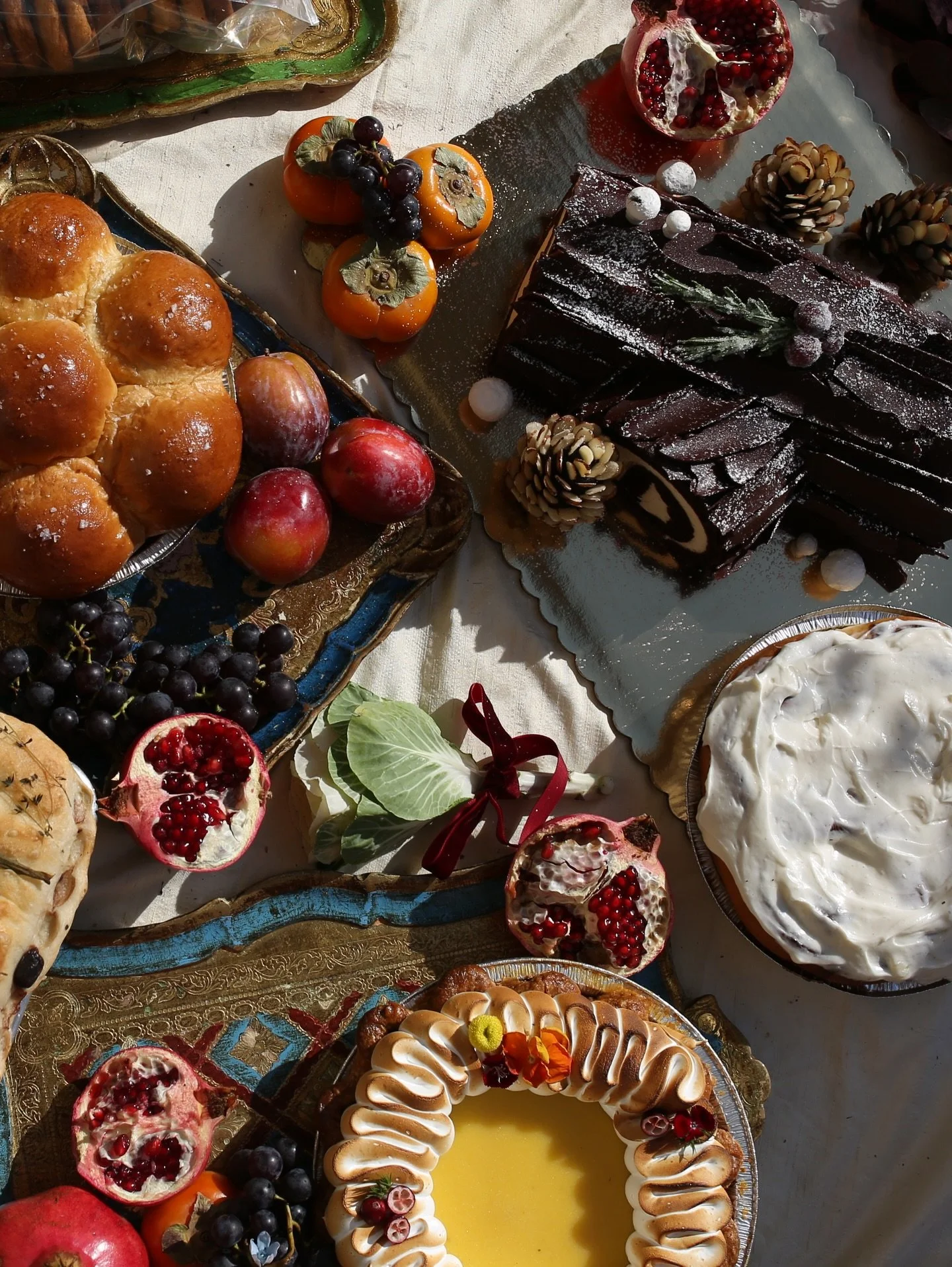 Online pre-ordering is now open for holiday specials 🕯️

Our B&ucirc;che de No&euml;l will be available for pickup Mon 12/22&mdash;Wed 12/24.

Lemon cranberry curd pie, Parker House dinner rolls, and packages of cinnamon rolls and chocolate chip coo