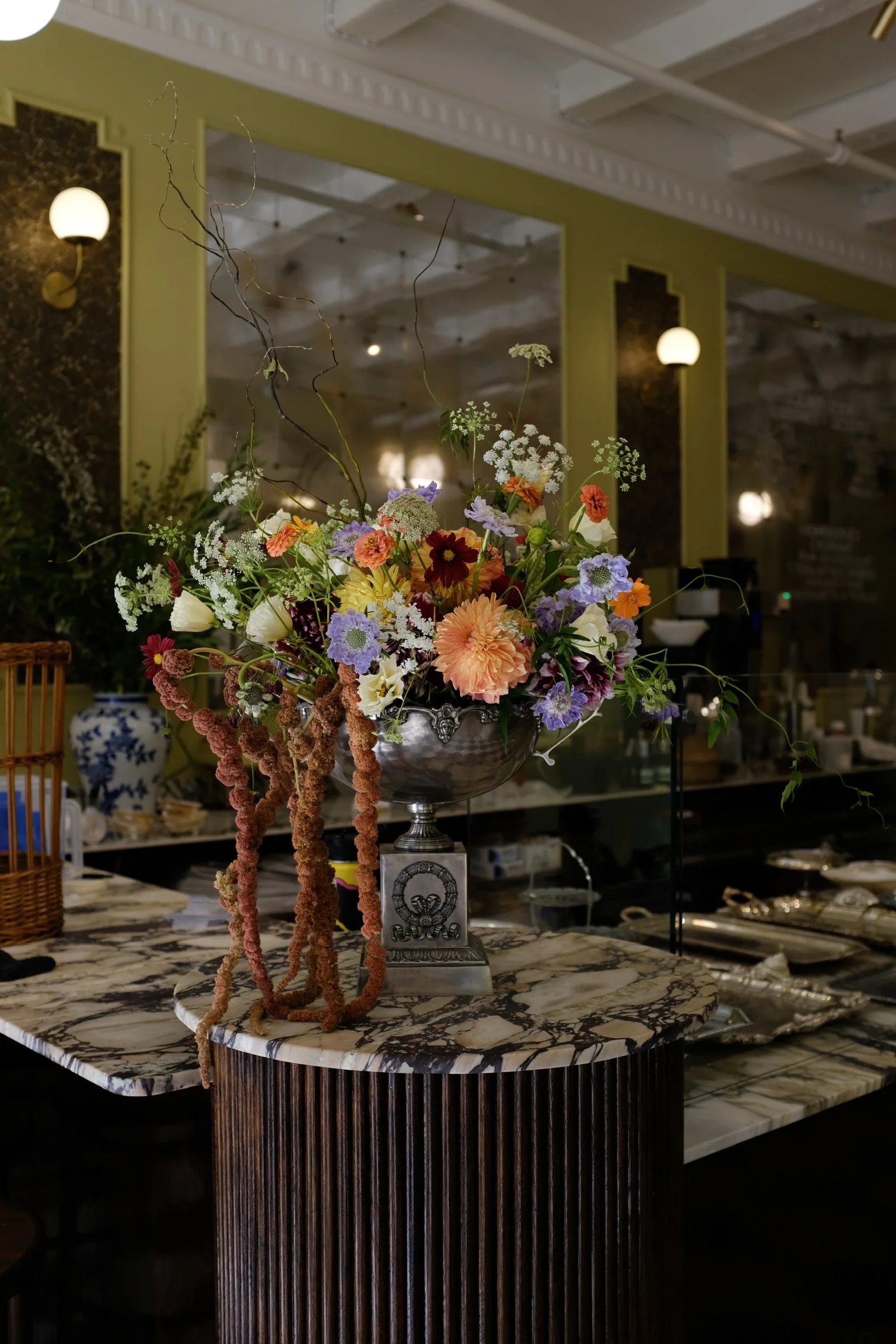 Interior of Elephantine Bakery’s café in Boston’s Fort Point, featuring fresh florals