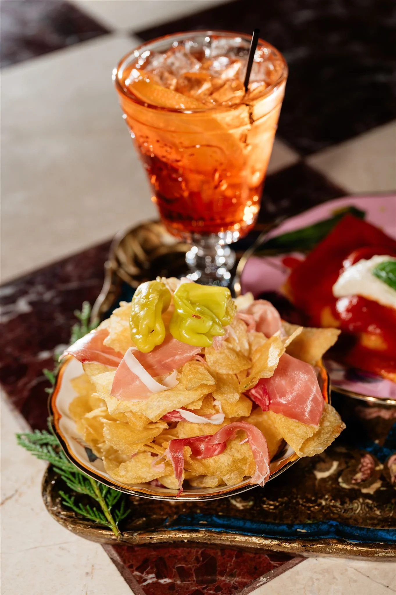 Aperol spritz with prosciutto and chips served at Elephantine Bakery in Boston near the Seaport