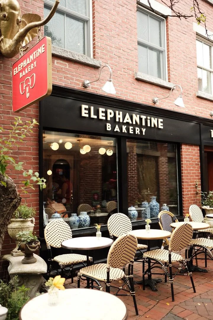 Exterior of Elephantine Bakery’s café in Portsmouth, featuring bistro tables and chairs