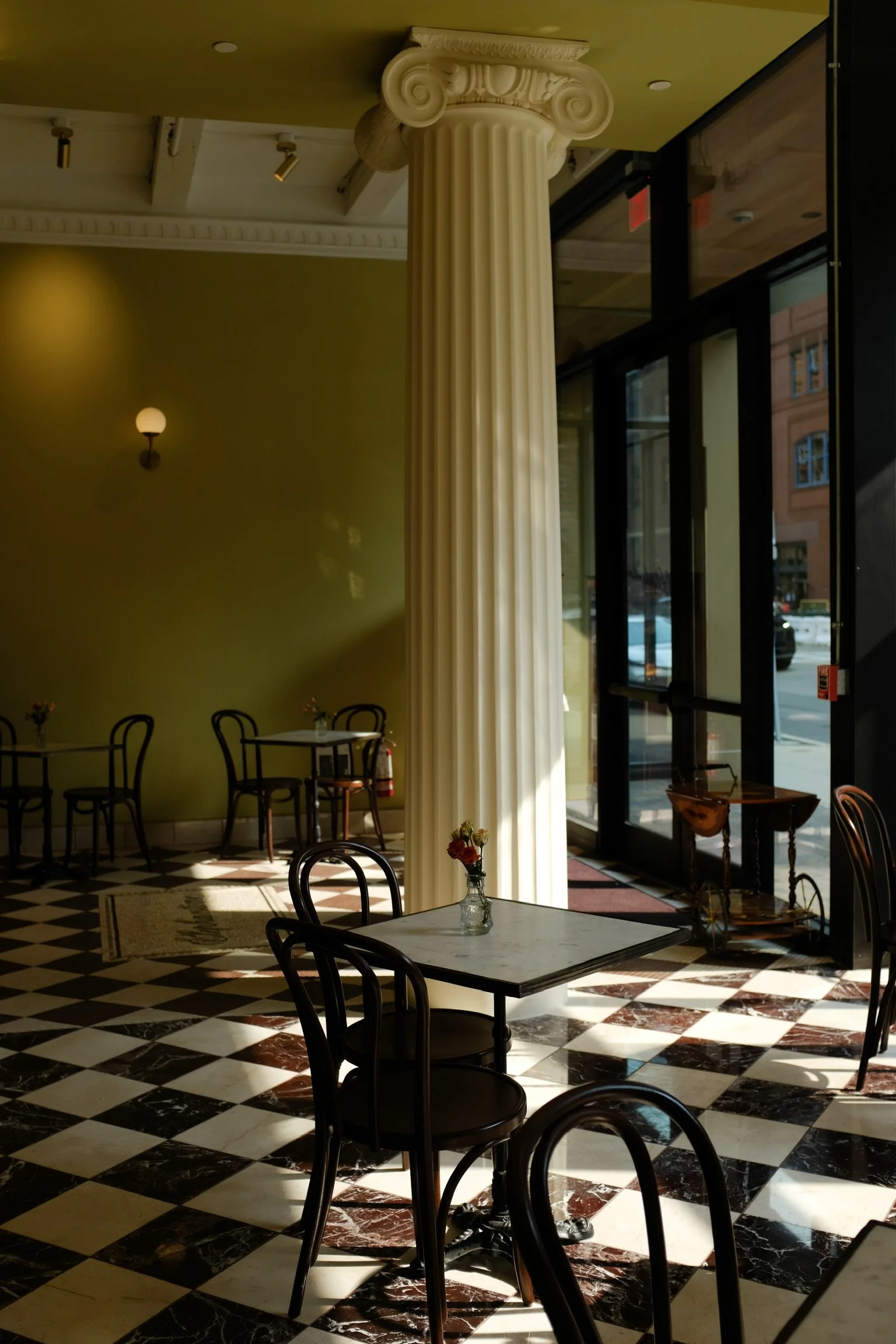 Interior of Elephantine Bakery’s café in Boston’s Fort Point, highlighting classical columns and architectural details