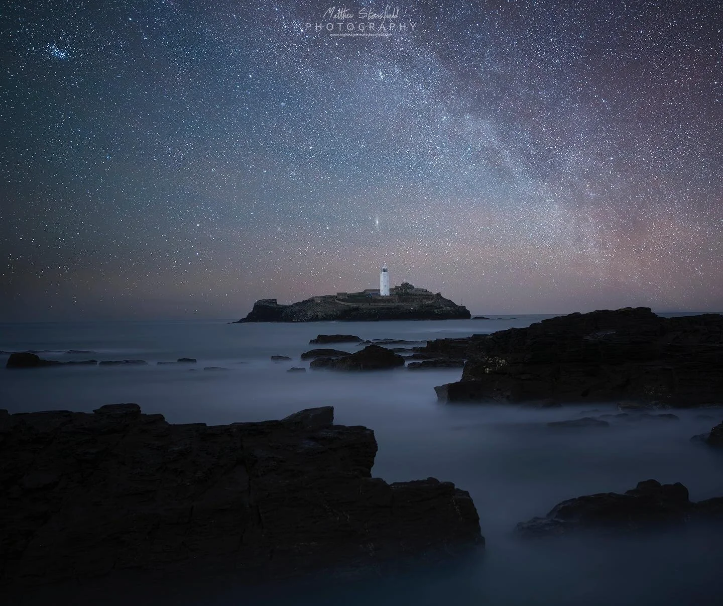 Godrevy Lighthouse - Cornwall
Web: www.nightskies.mattstansfield.com

Story: Another flashback to 2019 when I visited West Cornwall on a night of astrophotography. I remember I aimed to photograph the lighthouse with the Galaxy Adromona just behind w