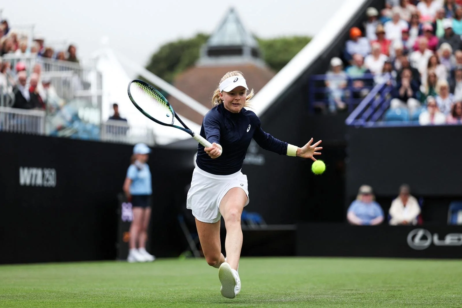 Harriet on court running to hit a shot