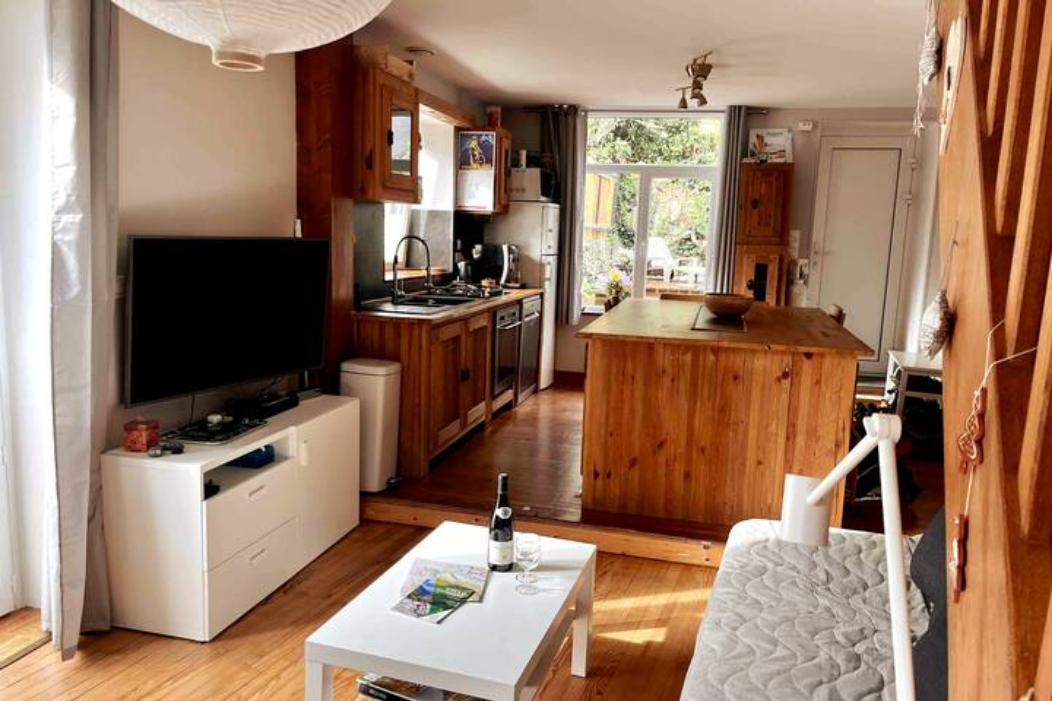 Living area with TV and kitchen.png
