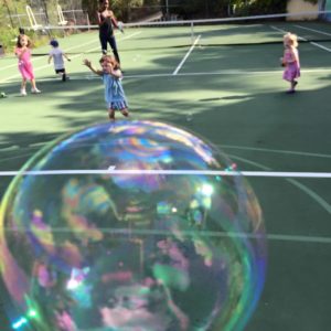 bubbles on tennis court with kids