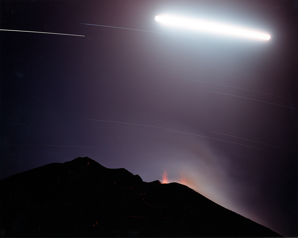  Hikers with flashlights on the slope of erupting volcano, Stromboli, Italy, 1994 