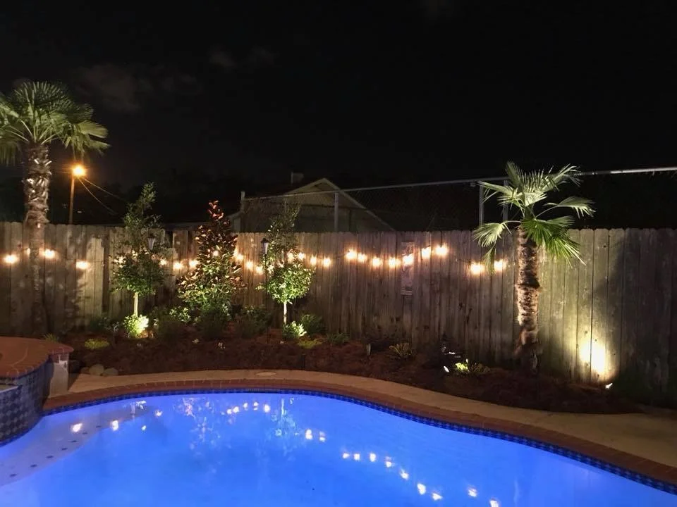 Metairie, LA: A poolside landscape design with lighting makes this backyard radiant!