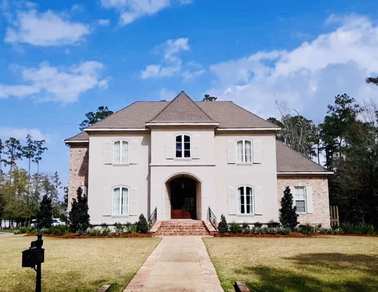 Teddy bear magnolias accentuate this beautiful residence in the Sanctuary Subdivision -Mandeville, LA.