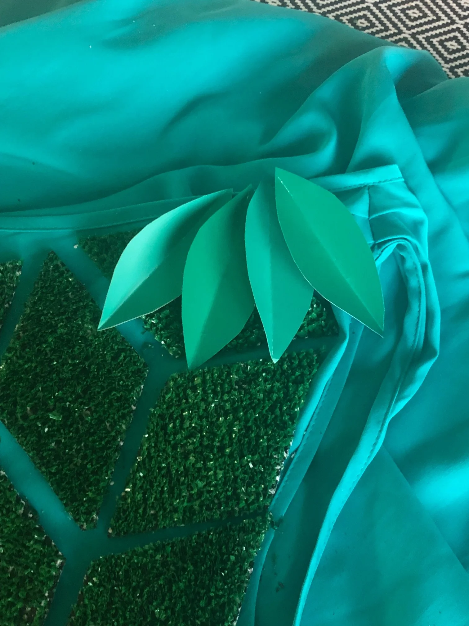 Paint sample leaves were sewn in layers along top edge of dress in the front and back.