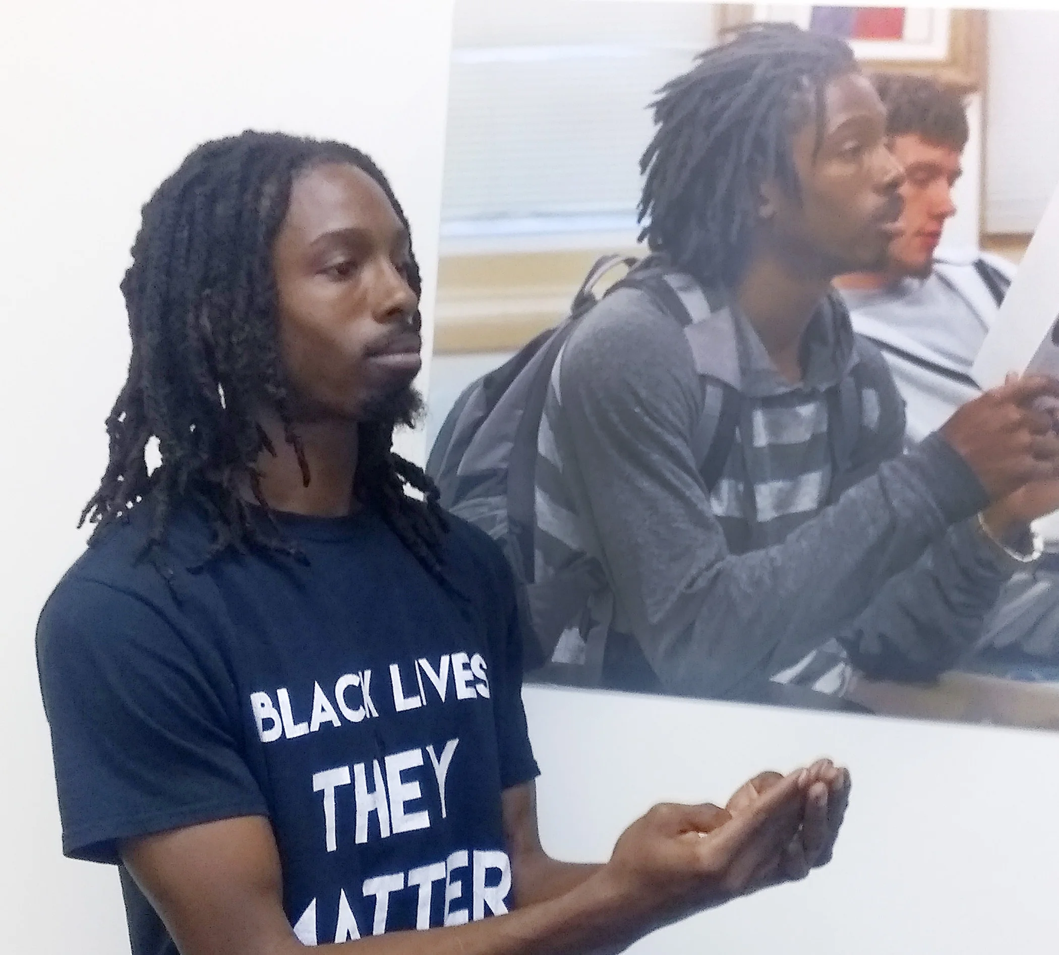 His photo is even on the wall in our conference room. During a recent visit, he recreated his pose in front of the old photo.