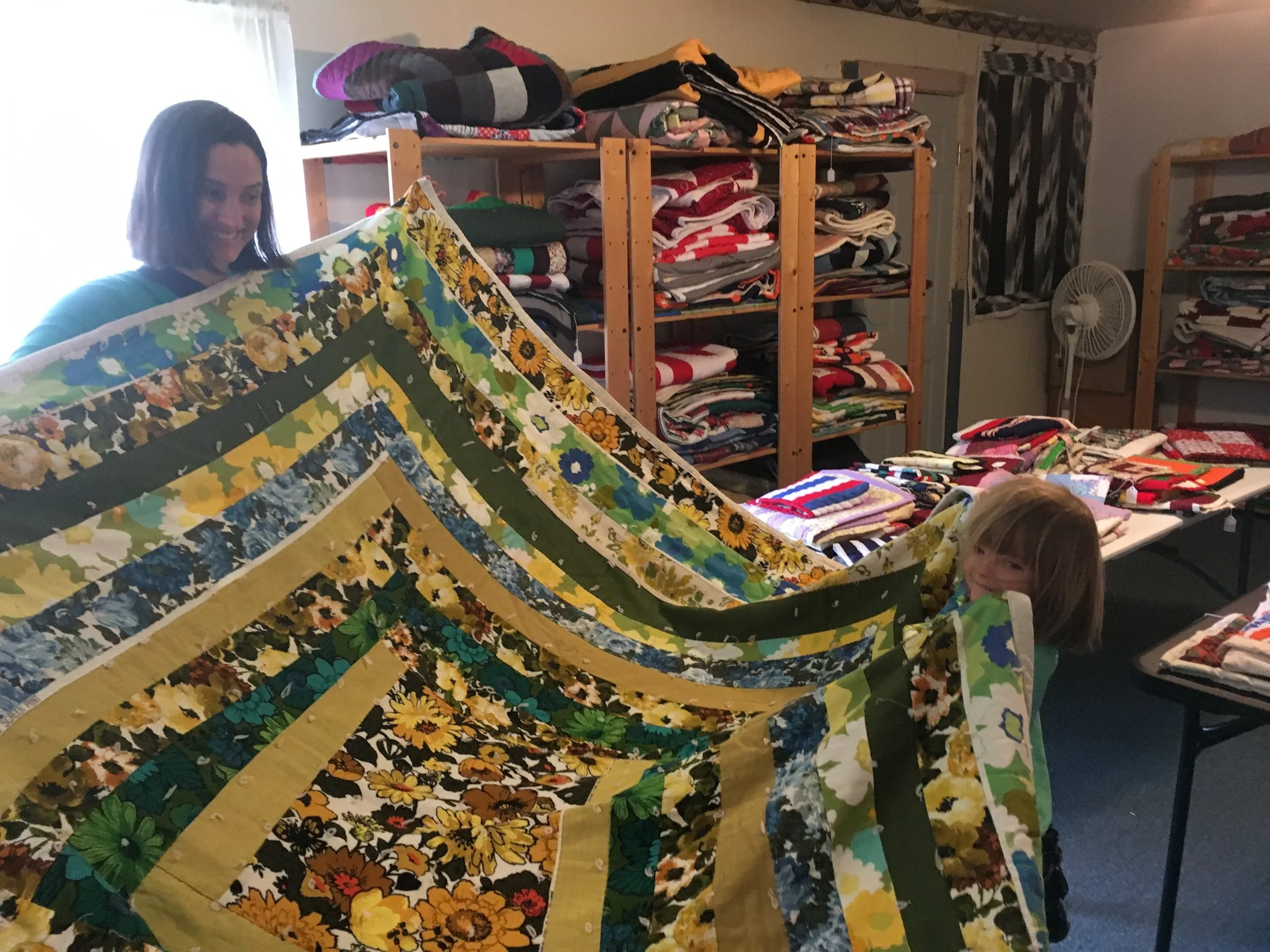My niece wanted to be wrapped up in every quilt in the shop. Me too.