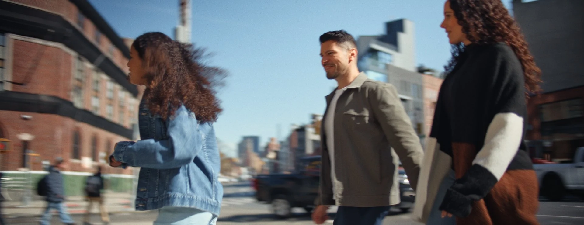  family crossing the street to shake shack for a meal. Family time. natural color vibe.  