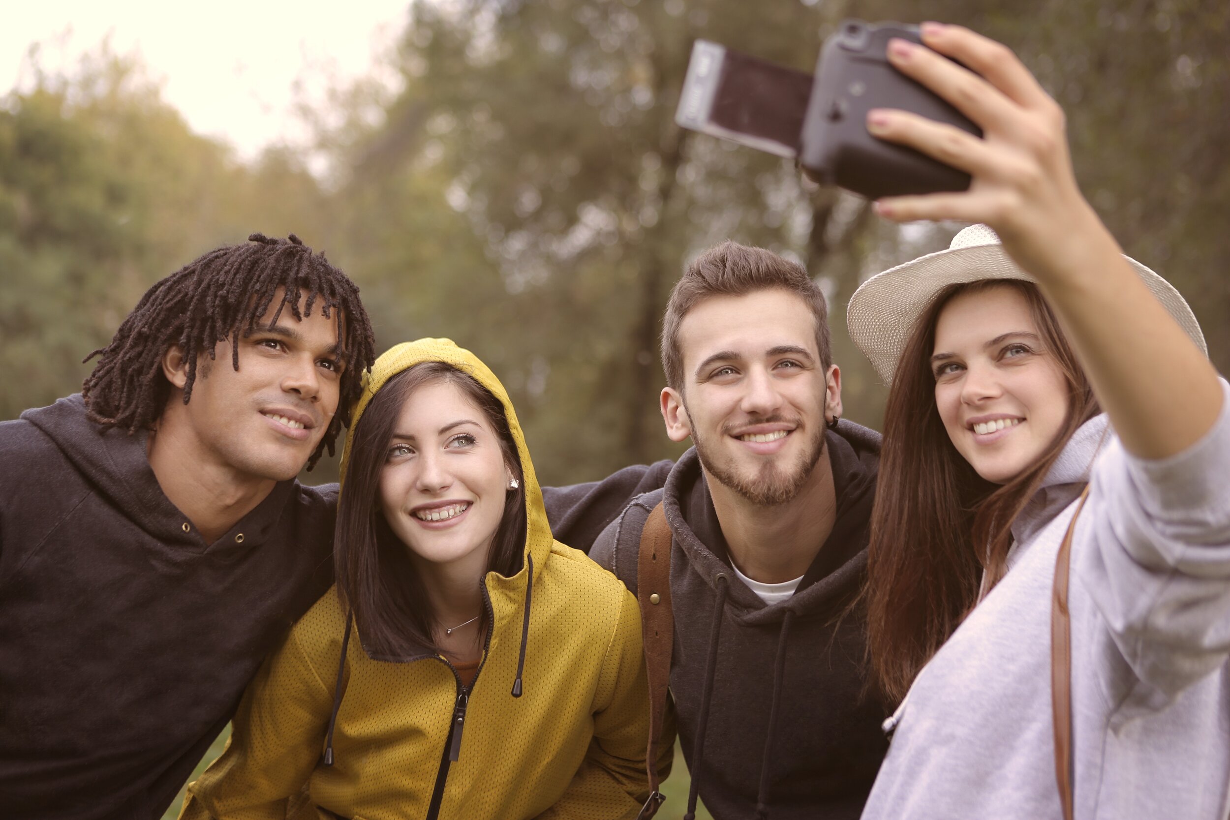 happy-diverse-friends-taking-selfie-in-park-3776813.jpg