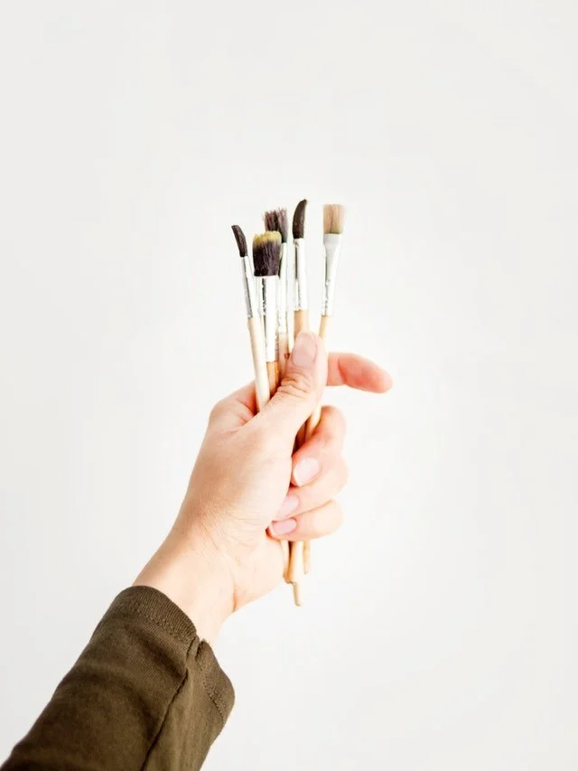 Person Holding Paint Brushes.jpg