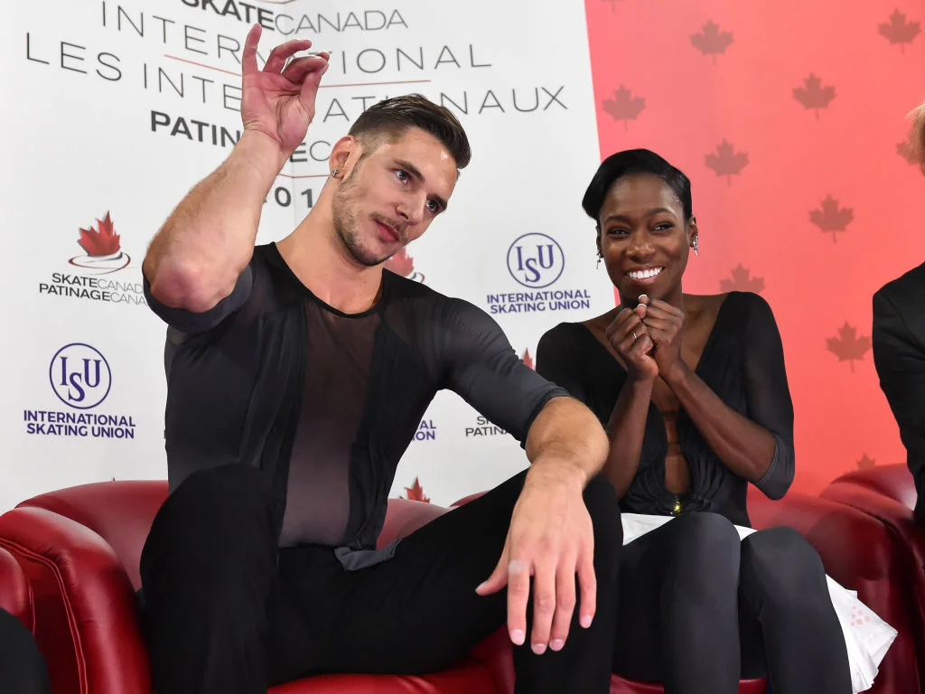 Vanessa James and Morgan Cipres celebrate in the Kiss & Cry after their record-breaking free program ( Photo credit: ISU )