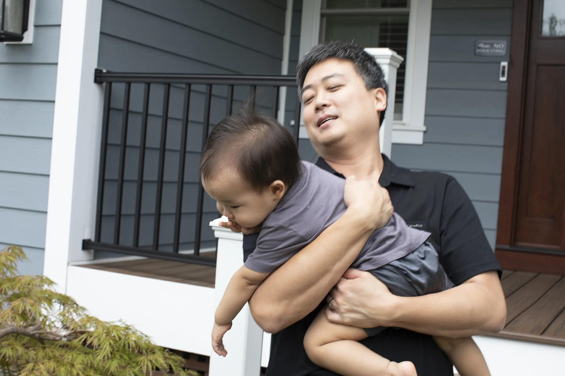 Pastor Daniel Park and son in front of their new parsonage in McLean, VA.