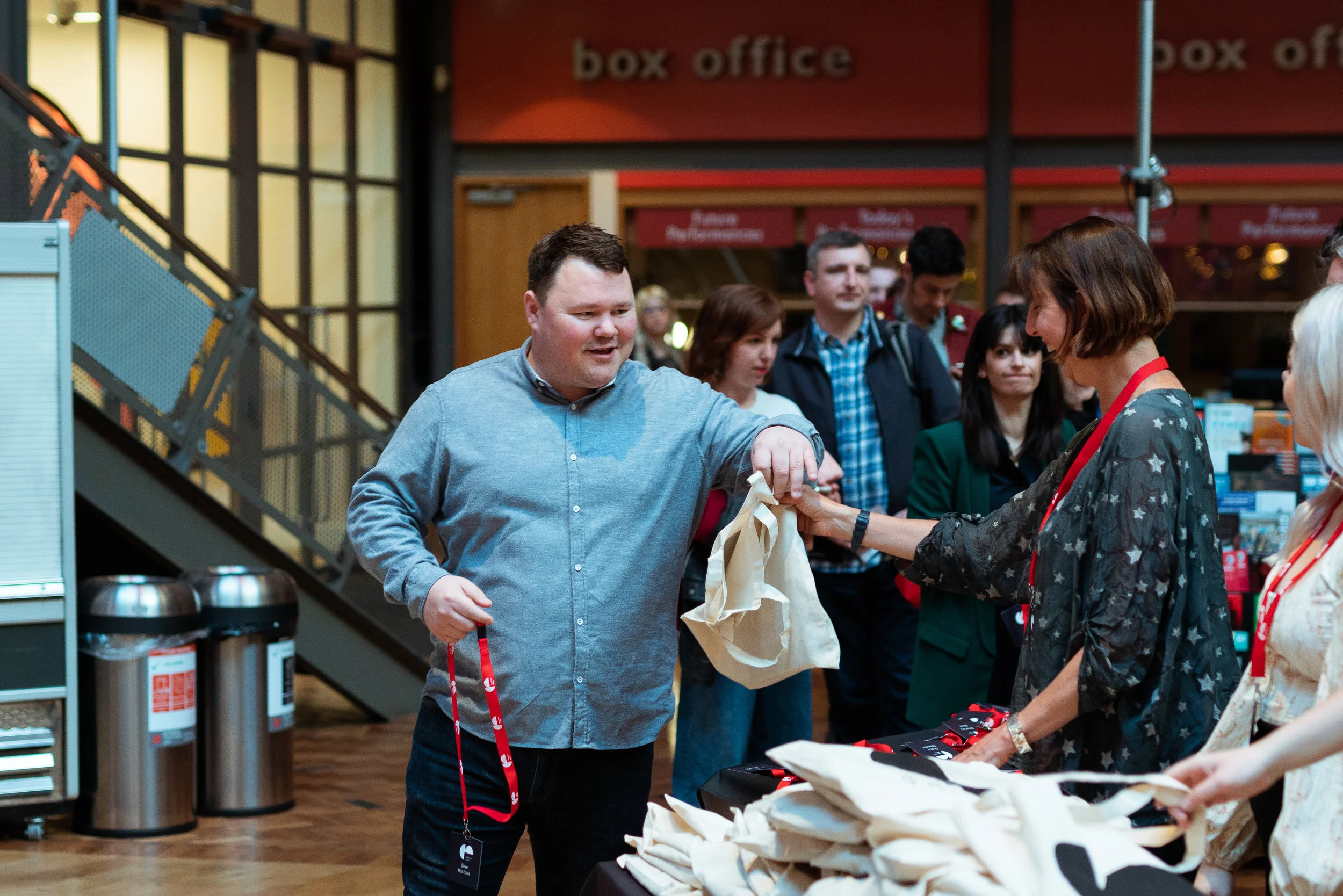 Lindsey Russell passing a well-stuffed bag to Dave Harland