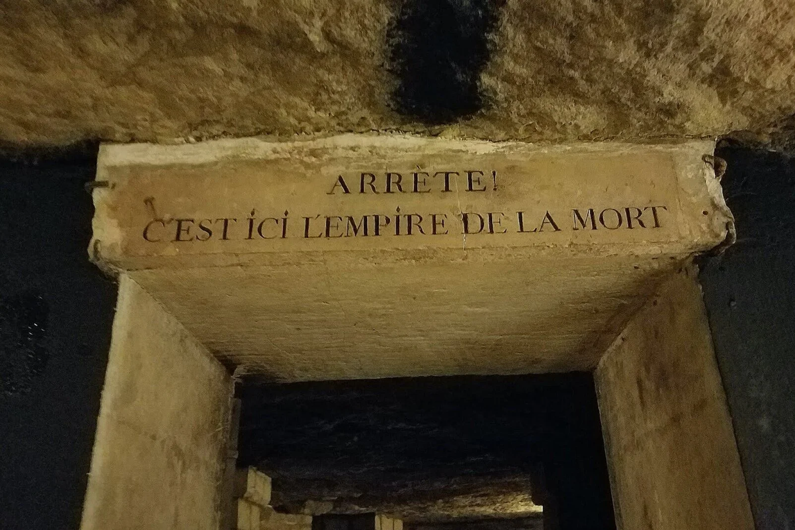 The entrance to the Paris Catacombs . “Stop!. This is the empire of the dead.”