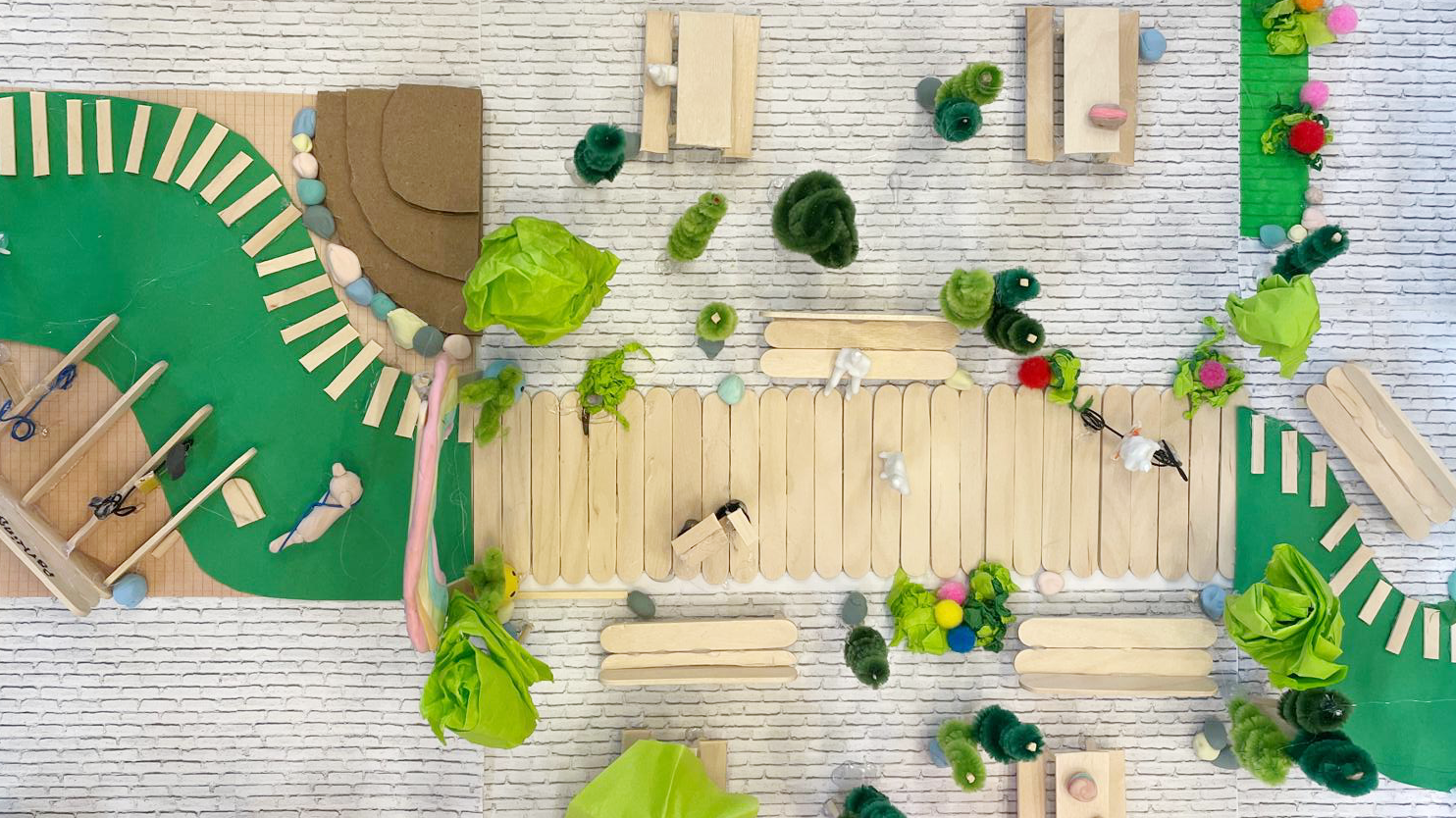 A student 3D model project of a community park complete with garden, bike racks, and walking paths.