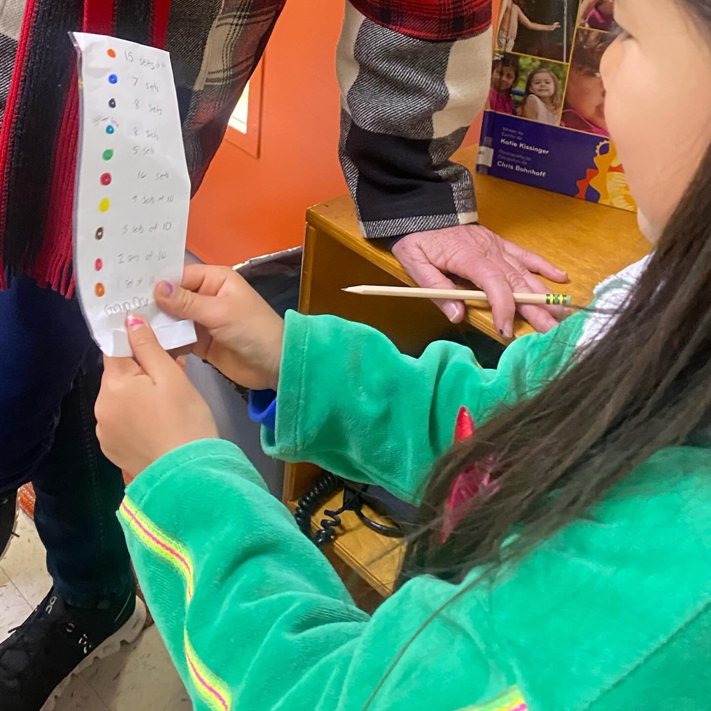 Children in Group One are preparing to measure the fire hose. Using the materials of the classroom, children are eagerly getting ready for their exciting day of measuring ahead.