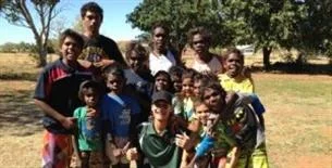Fitzroy Valley Remote Communities Athletics Workshops. Western Australian junior sprint champion, Asad Hosseini, with aspiring Yakanarra sprinters