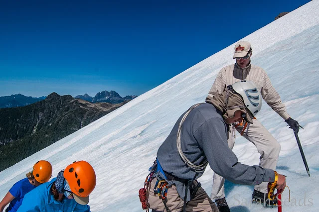 Blue skies above and blue ice below! Learning how to find good ice and set good anchors under the watchfull eye of Jan.