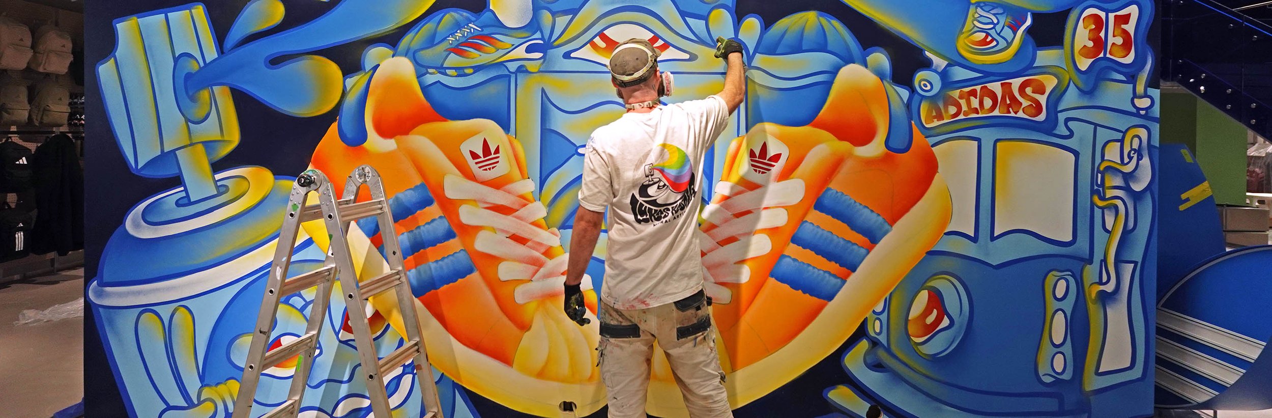 Lukas Kasper Melbourne Mural Artist painting a mural at Adidas in Melboune CBD