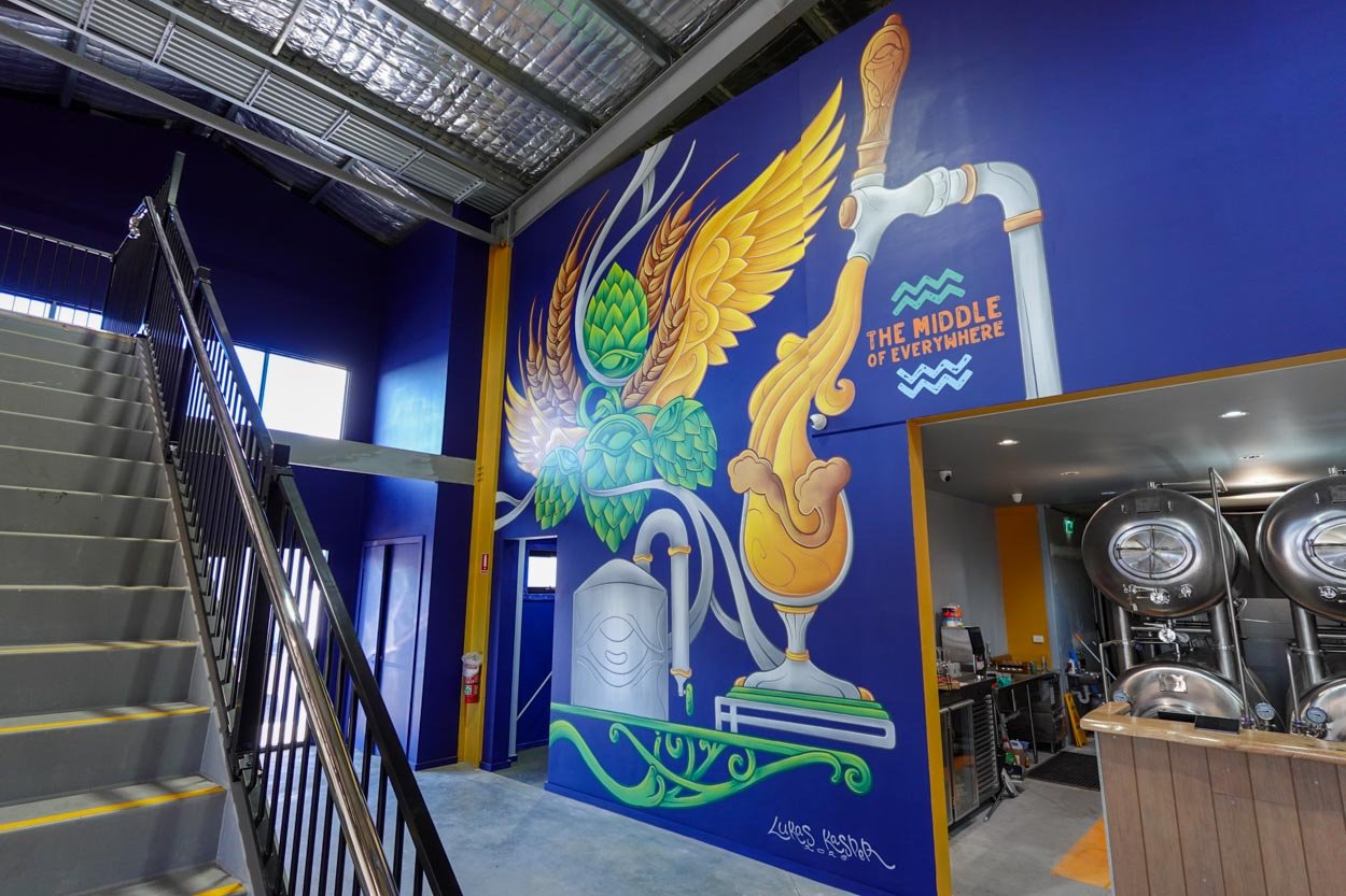 Brevet Brewing floor-to-ceiling brewery mural in Sale, Victoria, created by Melbourne mural artist Lukas Kasper in collaboration with The Middle of Everywhere, featuring aviation-inspired wings and abstract design.
