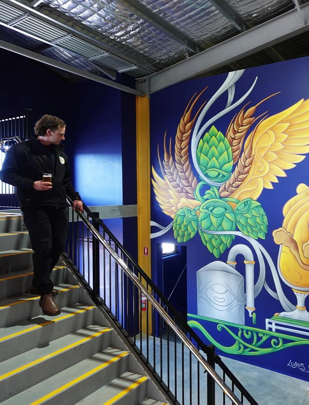 Brevet Brewing floor-to-ceiling brewery mural in Sale, Victoria, created by Melbourne mural artist Lukas Kasper in collaboration with The Middle of Everywhere, featuring aviation-inspired wings and abstract design.