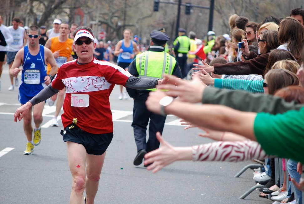  Boston, Mass. - April 20, 2009: A runner gets encouragement and high-fives from spectators at Audubon Circle, the last stretch of the Boston Marathon.  